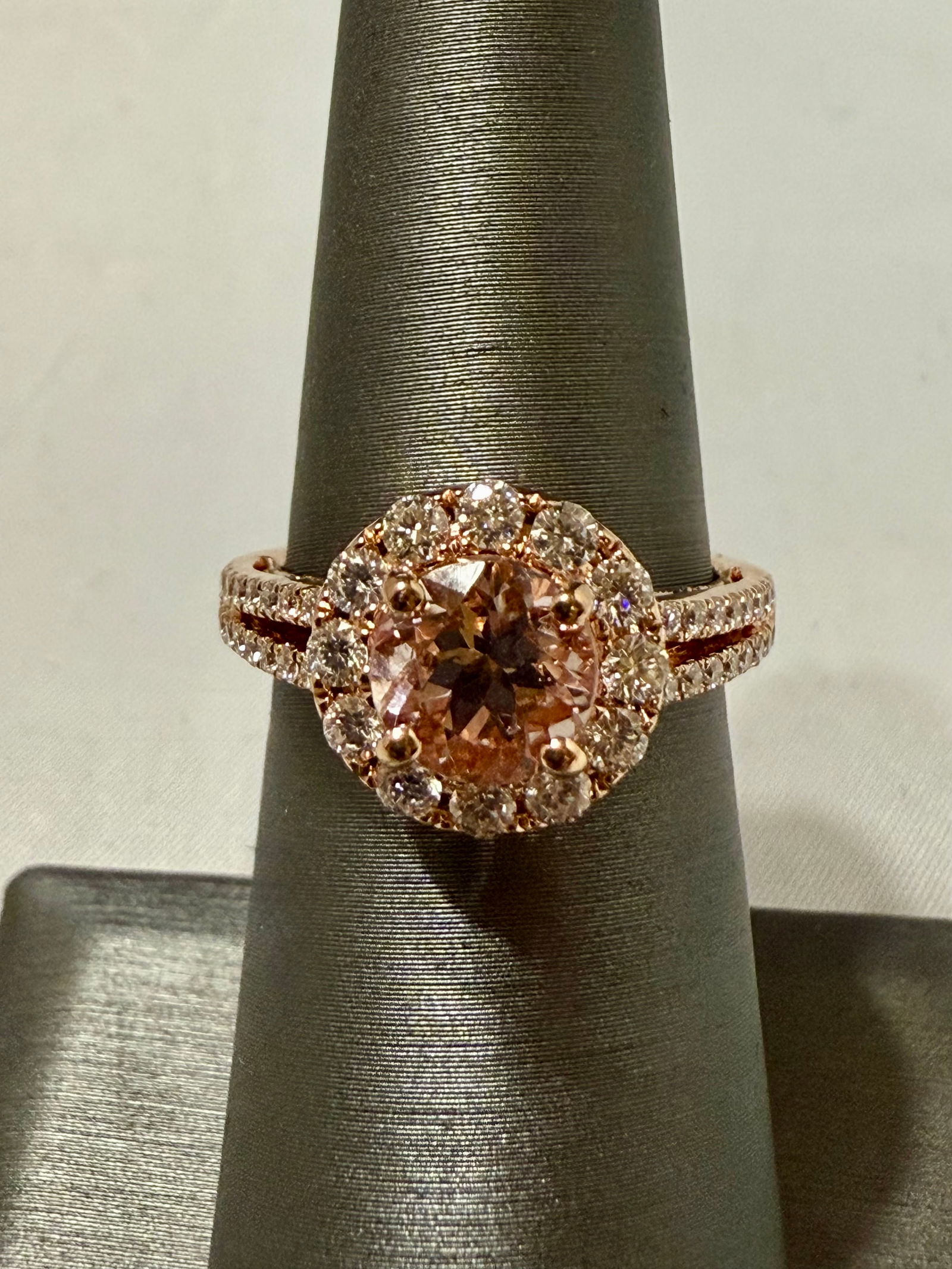 Pink Morganite and Diamond Ring, 14K Rose Gold Size 6.5: A vision of romance and radiance, this 14K rose gold ring features a captivating round-cut morganite of approximately 1.20 carats, encircled by a luminous halo of diamonds that continue along the spli