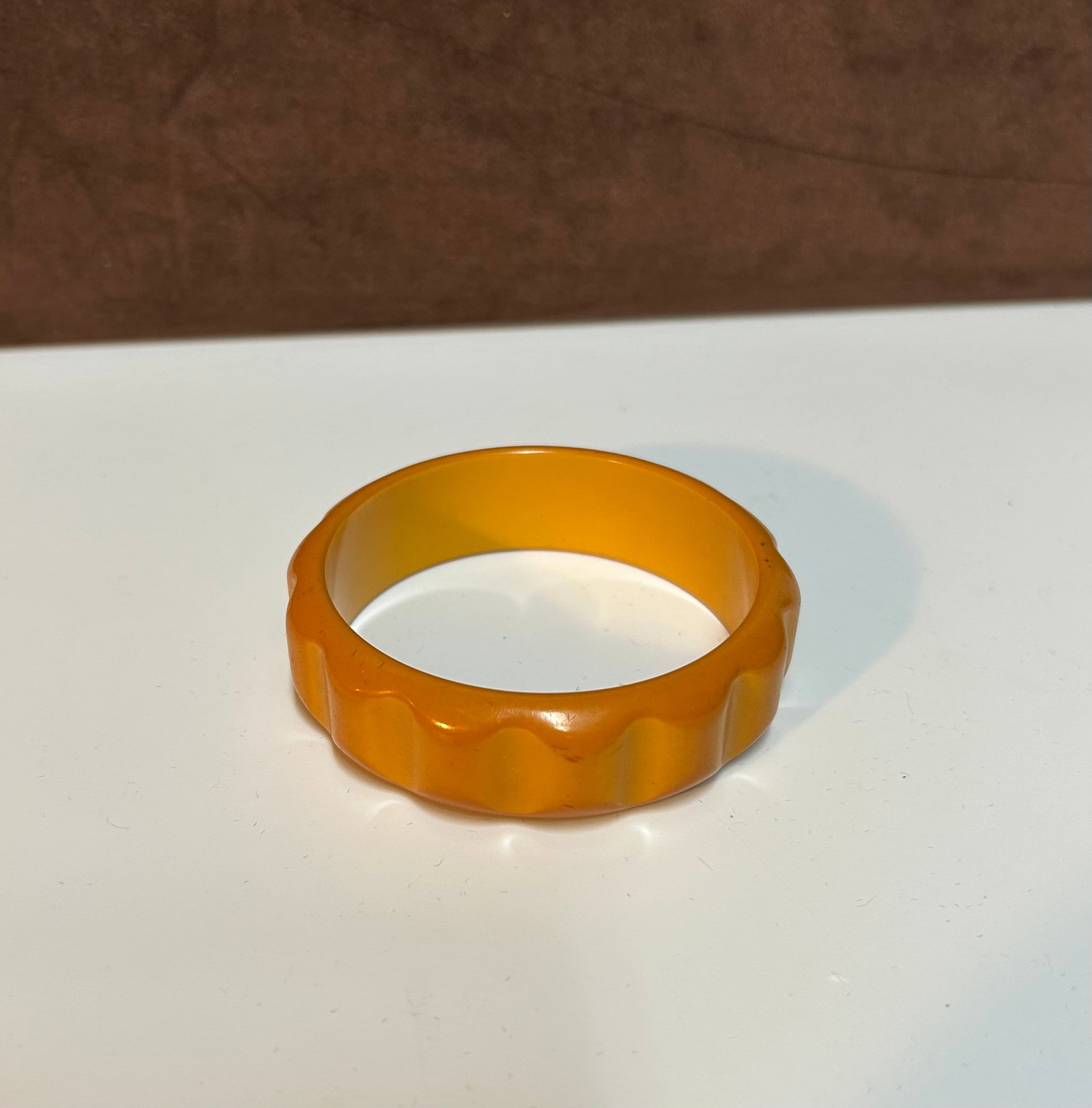 Art Deco Butterscotch Carved Bakelite Bangle Bracelet, Circa 1920s–1930s: This vibrant butterscotch Bakelite bangle dates from the Art Deco period (circa 1920s–1930s), when innovation and artistry converged to redefine fashion. Crafted from genuine phenolic Bakelite, this
