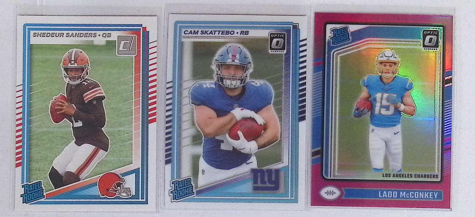 3 Donruss Optic & Donruss Rookies: Shedeur Sanders, Cam Skattebo, & Pink Holo Prizm Ladd McConkey (1 of 2)