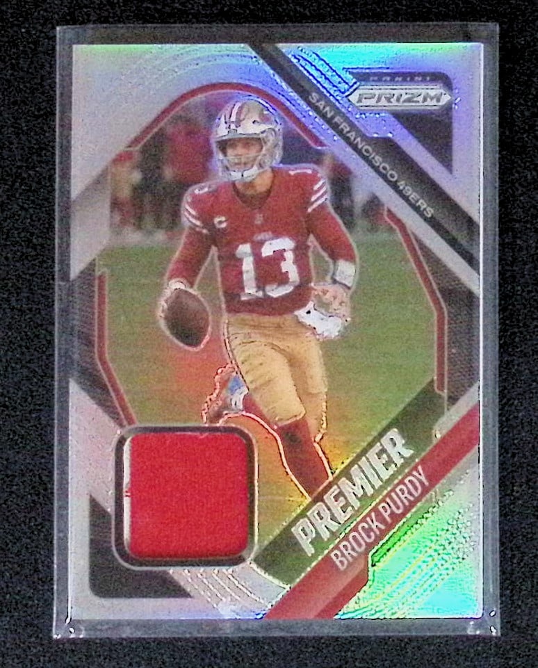 Brock Purdy Silver Prizm Premier Jerseys Patch Card 2025 Panini Prizm #PJY-BPY: Panini Select, Prizm, Mosaic, Contenders, Zenith, Phoenix, Illusions, Absolute, Rookie NFL Sports Trading Cards, SP, SSP, Cards, Football Cards for Sale Near Me, Superbowl & Hall of Fame Player Cards,