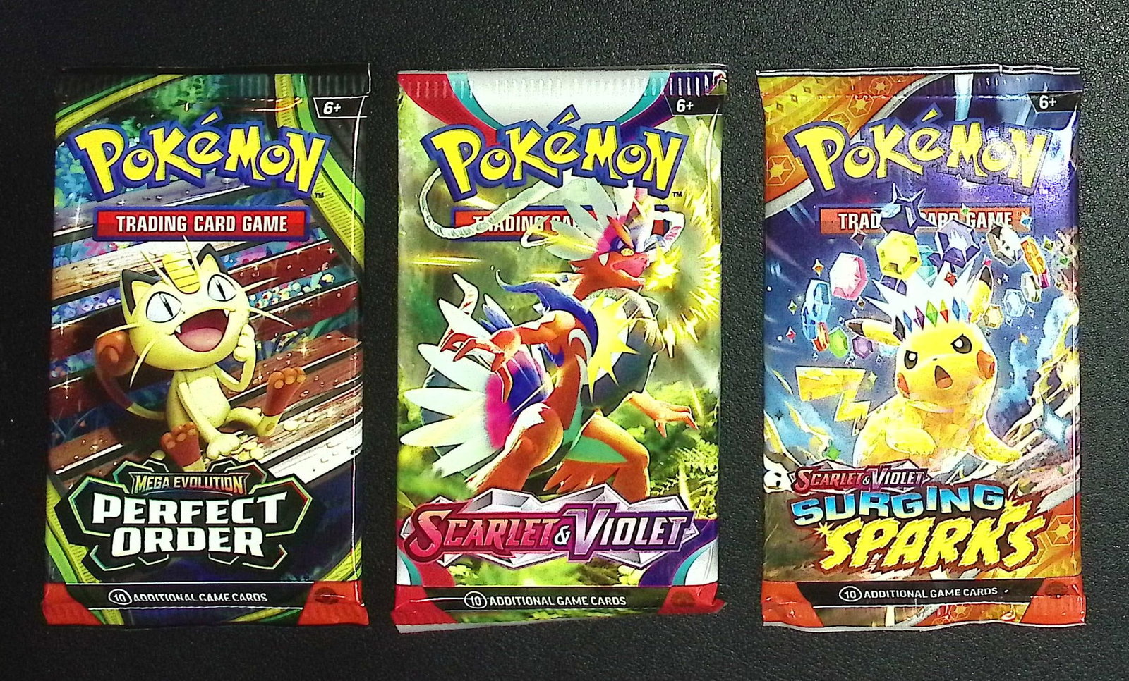 3 COUNT: 1 - Pokemon Perfect Order, 1 - Scarlet & Violet, & 1 - Surging Sparks Booster Packs: Pokemon Trading Card Game Cards, Charizard, Pikachu, Mewto, EX, Referse Holo, Holo Rare Cards, Secret Rare Cards, Full Art Cards, Evee, 3 Stars Ultra Rare Cards, Double Rare, Illustration Rare, Specia
