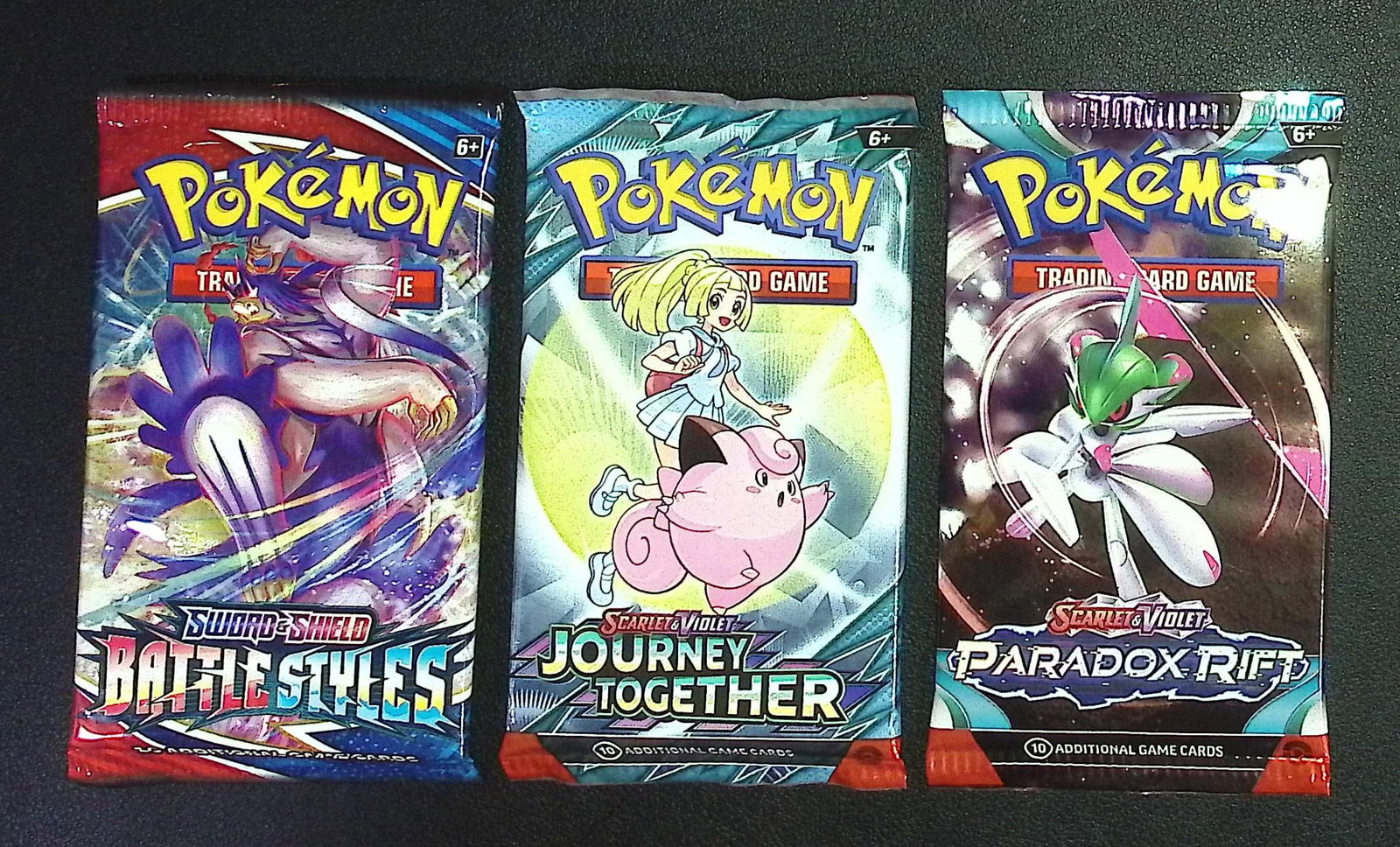 3 COUNT: 1 - Pokemon Battle Styles, 1 - Journey Together, & 1 - Paradox Rift Booster Packs: Pokemon Trading Card Game Cards, Charizard, Pikachu, Mewto, EX, Referse Holo, Holo Rare Cards, Secret Rare Cards, Full Art Cards, Evee, 3 Stars Ultra Rare Cards, Double Rare, Illustration Rare, Specia