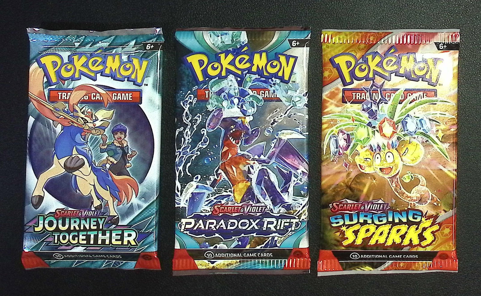 3 COUNT: 1 - Pokemon Journey Together, 1 - Paradox Rift, & 1 - Surging Sparks Booster Packs: Pokemon Trading Card Game Cards, Charizard, Pikachu, Mewto, EX, Referse Holo, Holo Rare Cards, Secret Rare Cards, Full Art Cards, Evee, 3 Stars Ultra Rare Cards, Double Rare, Illustration Rare, Specia