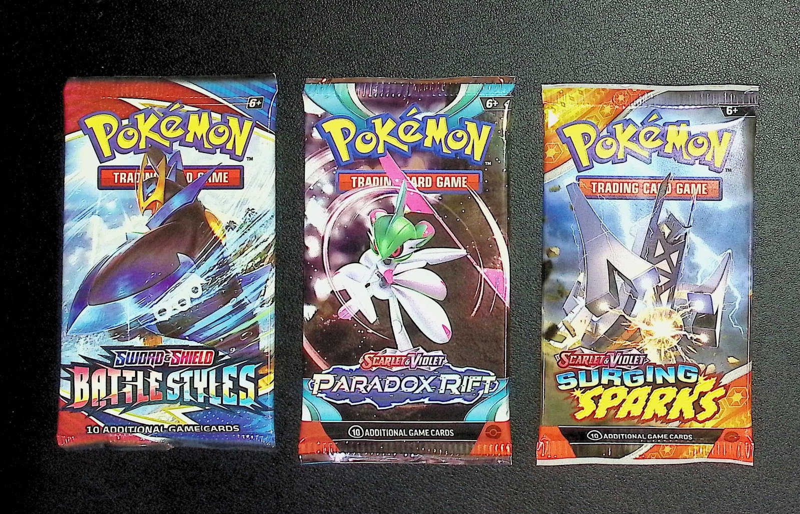 3 COUNT: 1 - Pokemon Battle Styles, 1 - Paradox Rift, & 1 - Surging Sparks Booster Packs: Pokemon Trading Card Game Cards, Charizard, Pikachu, Mewto, EX, Referse Holo, Holo Rare Cards, Secret Rare Cards, Full Art Cards, Evee, 3 Stars Ultra Rare Cards, Double Rare, Illustration Rare, Specia