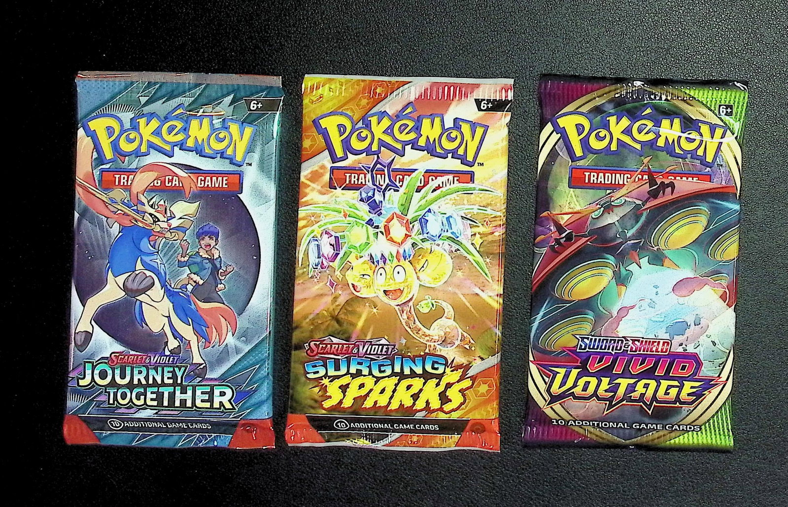 3 COUNT: 1 - Pokemon Journey Together, 1 - Surging Sparks, 1 - Vivid Voltage Booster Packs (1 of 1)