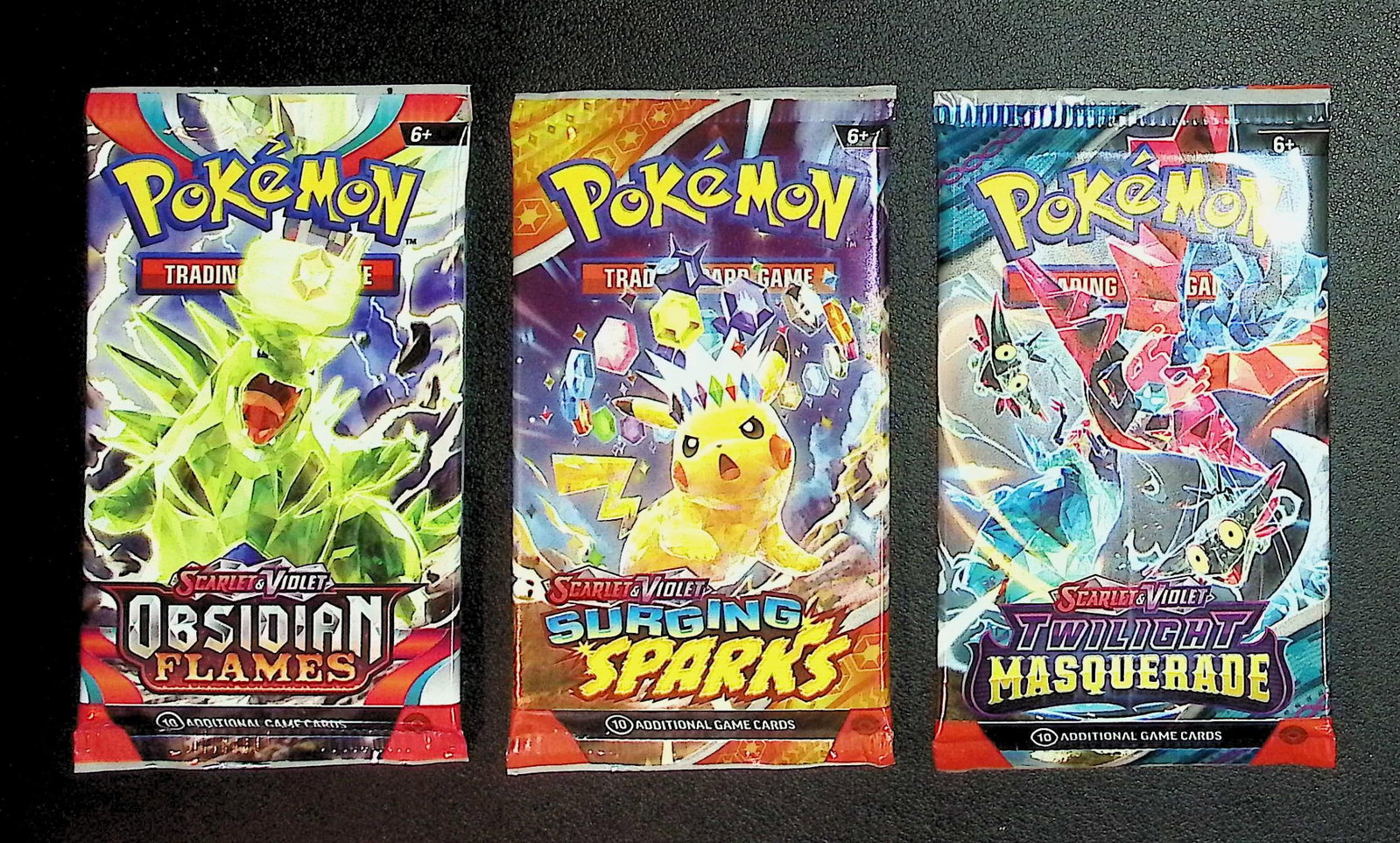 3 COUNT: 1 - Pokemon Obsidian Flames, 1 - Surging Sparks, & 1 - Twilight Masquerade Booster Packs: Pokemon Trading Card Game Cards, Charizard, Pikachu, Mewto, EX, Referse Holo, Holo Rare Cards, Secret Rare Cards, Full Art Cards, Evee, 3 Stars Ultra Rare Cards, Double Rare, Illustration Rare, Specia