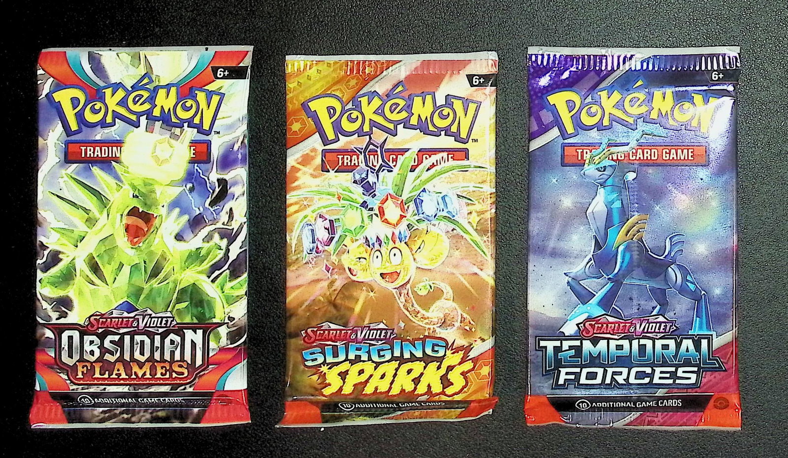 3 COUNT: 1 - Pokemon Obsidian Flames, 1 - Surging Sparks, & 1 - Temporal Forces Booster Packs: Pokemon Trading Card Game Cards, Charizard, Pikachu, Mewto, EX, Referse Holo, Holo Rare Cards, Secret Rare Cards, Full Art Cards, Evee, 3 Stars Ultra Rare Cards, Double Rare, Illustration Rare, Specia