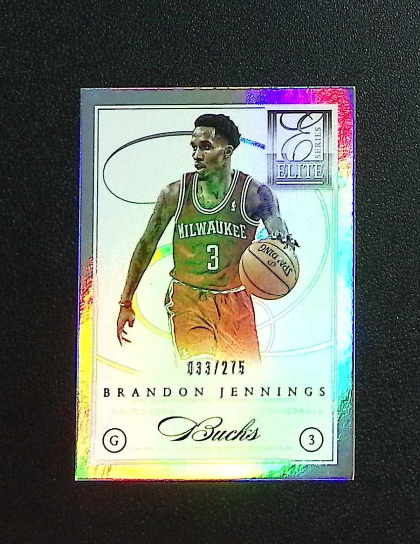 Brandon Jennings /275 2012-13 Panini Elite Series #88: Panini, Donruss Optic, Donruss Select, Prizm, Mosaic, Contenders, Revolution, Phoenix, NBA Hoops, Rookie NFL Sports Trading Cards, Silver, SP, SSP, Wave Prizms, Numbered Cards, Basketball sports Cards