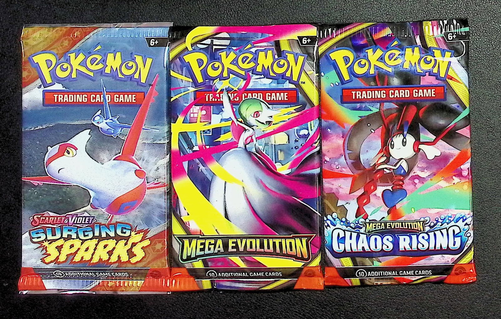 3 COUNT: 1 - Pokemon Chaos Rising, 1 - Mega Evolution, & 1 - Surging Sparks Booster Packs: Pokemon Trading Card Game Cards, Charizard, Pikachu, Mewto, EX, Referse Holo, Holo Rare Cards, Secret Rare Cards, Full Art Cards, Evee, 3 Stars Ultra Rare Cards, Double Rare, Illustration Rare, Specia