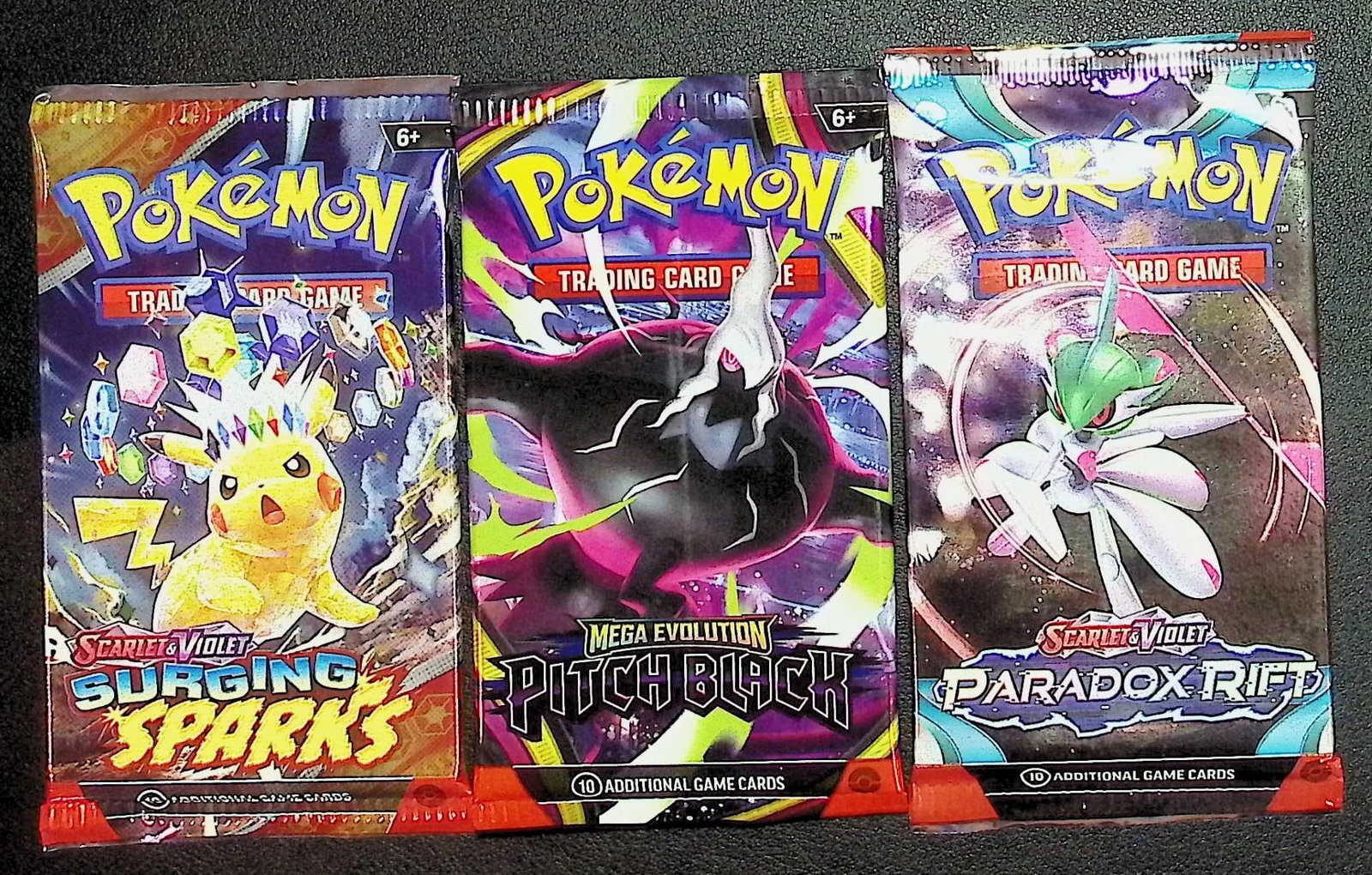 3 COUNT: 1 - Pokemon Paradox Rift, 1 - Pitch Black, & 1 - Surging Sparks Booster Packs: Pokemon Trading Card Game Cards, Charizard, Pikachu, Mewto, EX, Referse Holo, Holo Rare Cards, Secret Rare Cards, Full Art Cards, Evee, 3 Stars Ultra Rare Cards, Double Rare, Illustration Rare, Specia