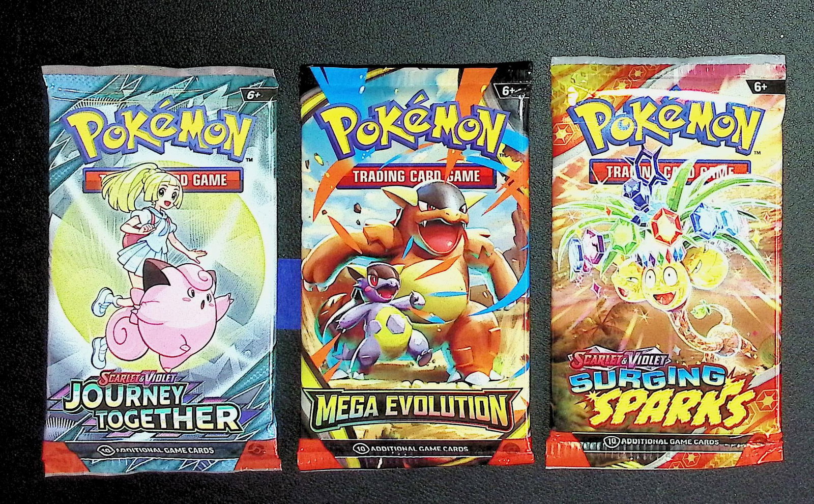 3 COUNT: 1 - Pokemon Journey Together, 1 - Mega Evolution & 1 - Surging Sparks Booster Packs: Pokemon Trading Card Game Cards, Charizard, Pikachu, Mewto, EX, Referse Holo, Holo Rare Cards, Secret Rare Cards, Full Art Cards, Evee, 3 Stars Ultra Rare Cards, Double Rare, Illustration Rare, Specia