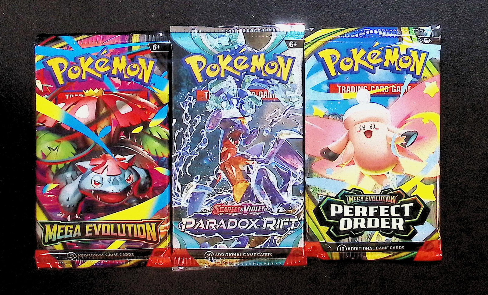 3 COUNT: 1 - Pokemon Mega Evolution, 1 - Perfect Order, & 1 - Paradox Rift Booster Packs: Pokemon Trading Card Game Cards, Charizard, Pikachu, Mewto, EX, Referse Holo, Holo Rare Cards, Secret Rare Cards, Full Art Cards, Evee, 3 Stars Ultra Rare Cards, Double Rare, Illustration Rare, Specia