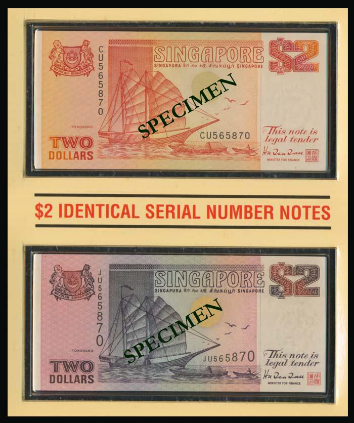 Singapore $2 1990 1992 ship orange & purple: Singapore $2, (1990, 1992), ship, orange and purple, the orange with prefix CU, the purple with prefix JU, both with identical serial no. 565870, in folder of issue, marketed by the Singapore Mint.