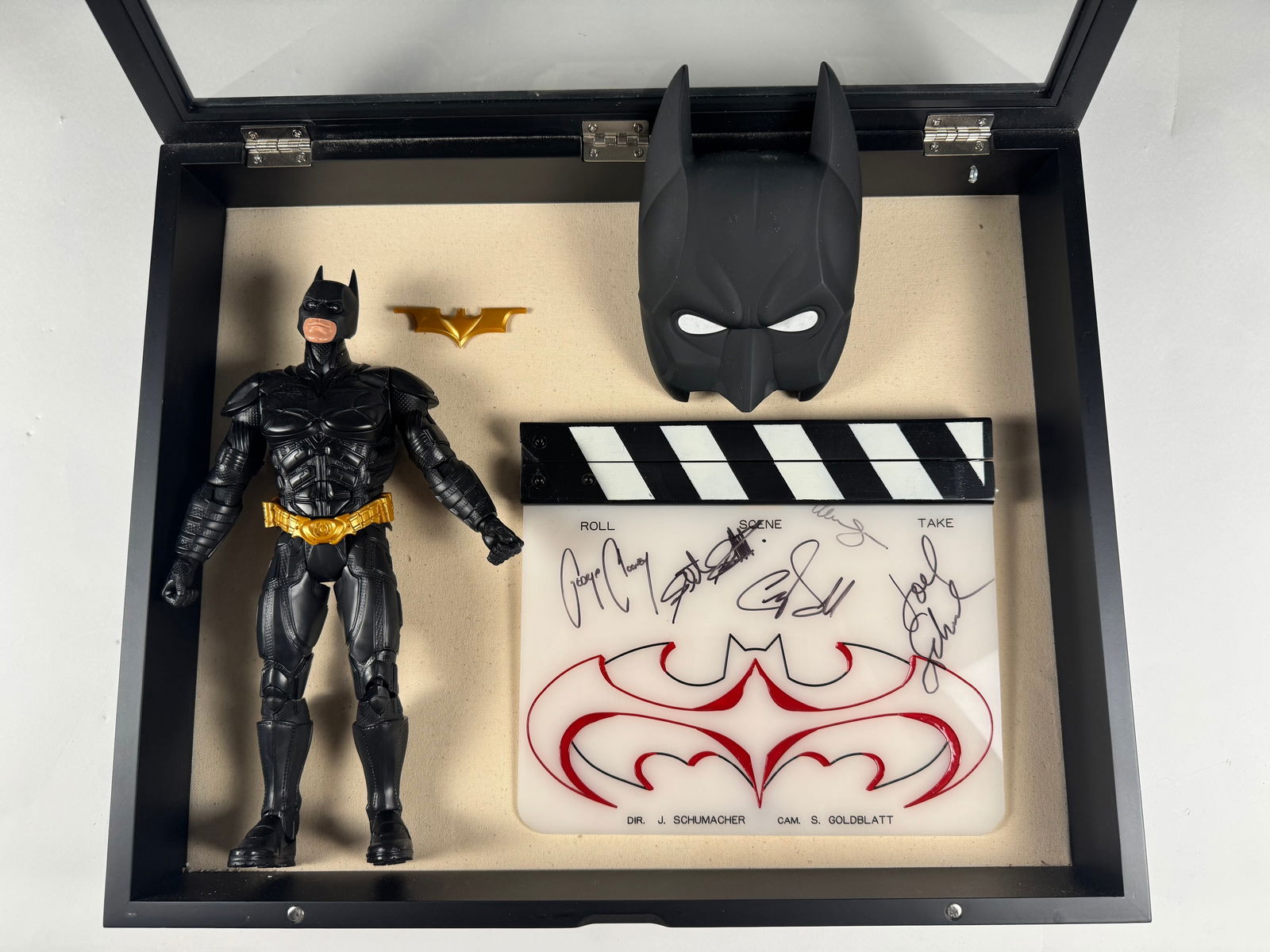 Batman and Robin Autograph Signed Clapperboard, Action Figure and The Dark Knight DVD set: This is one of the most exciting pieces from Gil's estate: an original clapperboard signed by the cast and director of Batman and Robin. Clearly you can see George Clooney and Joel Shumacher, less cle