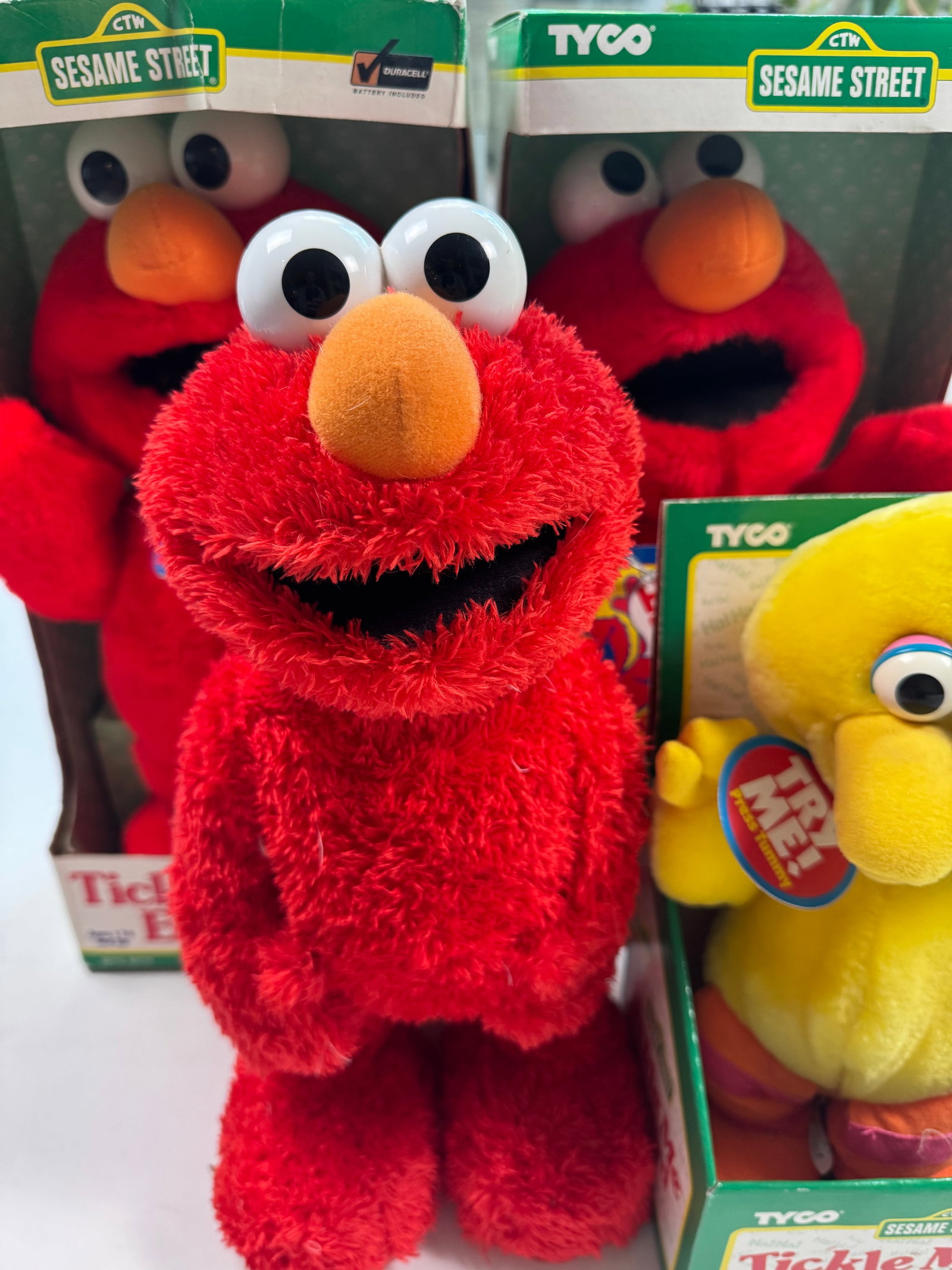 Lot of 4 Tickle Me Sesame Street Collectors Toys 3 Elmo and 1 Big Bird: This lot includes two Tickle Me Elmo toys still in the box (we do not know if they work or not), one Tickle Me Elmo toy not in box that seems to be a different edition as it is heavier and has buttons