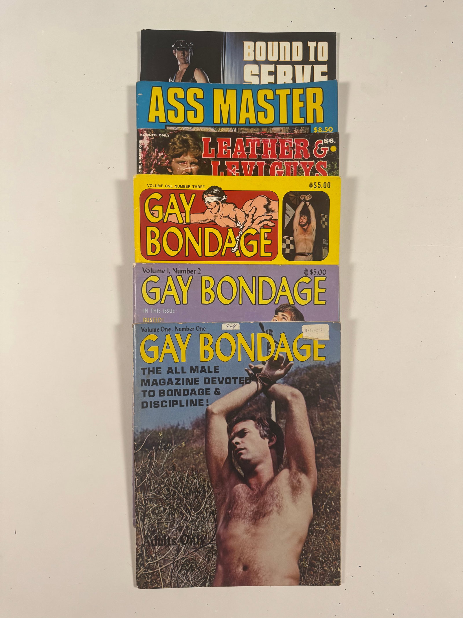 Lot of 6 Gay S&M SM Bondage Magazines: Titles include Gay Bondage 1, 2 and 3, Leather and Levi Guys, Ass Master and Bound to Serve