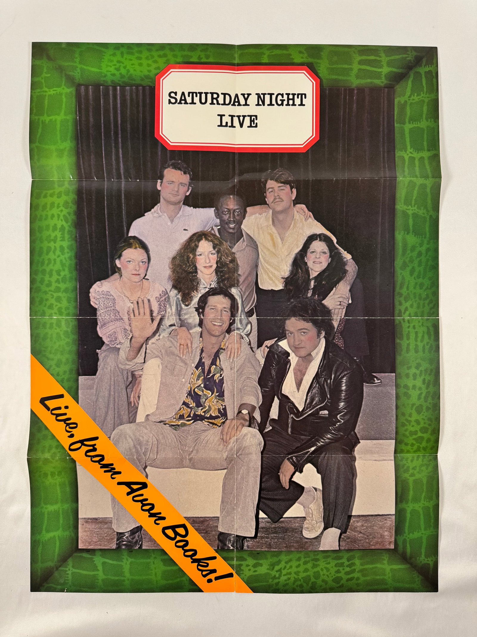 SNL Live from Avon Books Extremely Rare 1975 Promotional Poster Season One Original Cast 27"x20: Promotional poster folded in quarters as received from publisher's publicity dept. Features the original cast of Saturday Night Live as replicated on the published book cover: Laraine Newman, John Bel