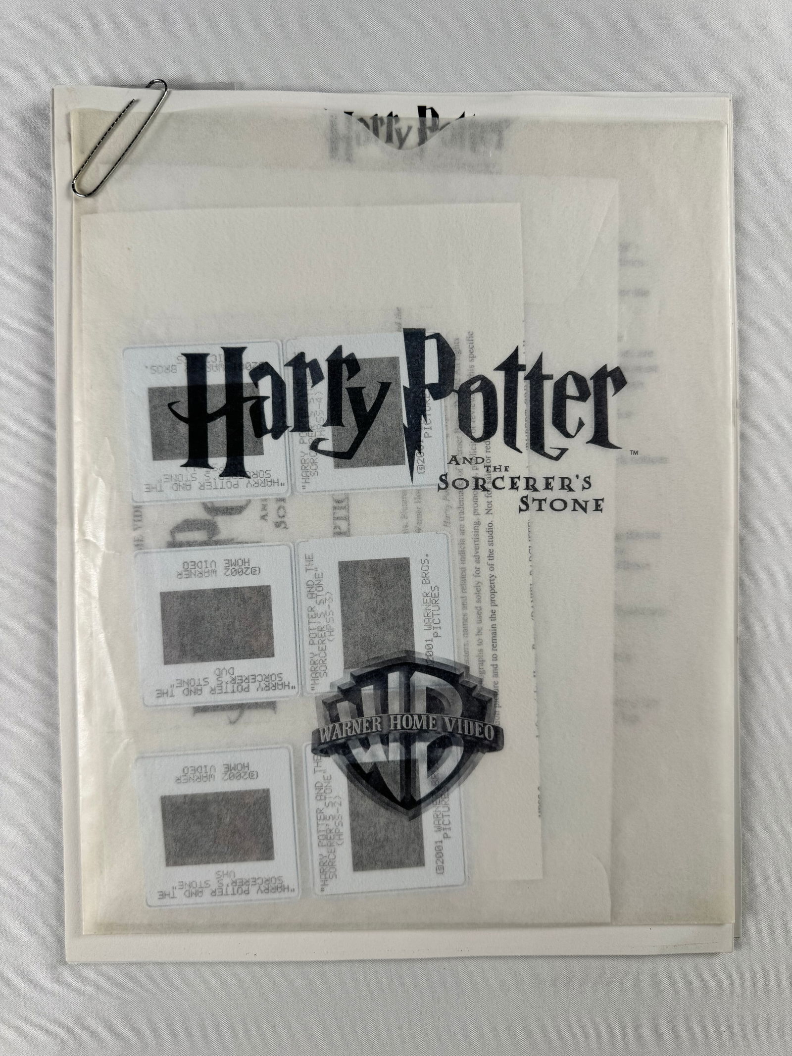 Lot of 6 Harry Potter 35mm Slides in Plastic Sheet: Group of six 35mm mounted slides showing Harry Potter–related imagery, including character stills and a title image. Slides are stored in a clear plastic sheet and photographed while being held.