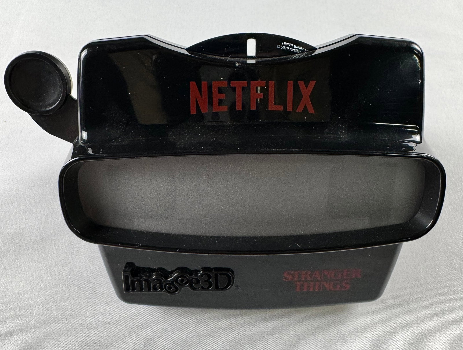 Netflix Stranger Things Imago3D View-Master Viewfinder Viewer Device: Black plastic viewing device branded 'NETFLIX' with 'Imago3D' and 'Stranger Things' markings visible.