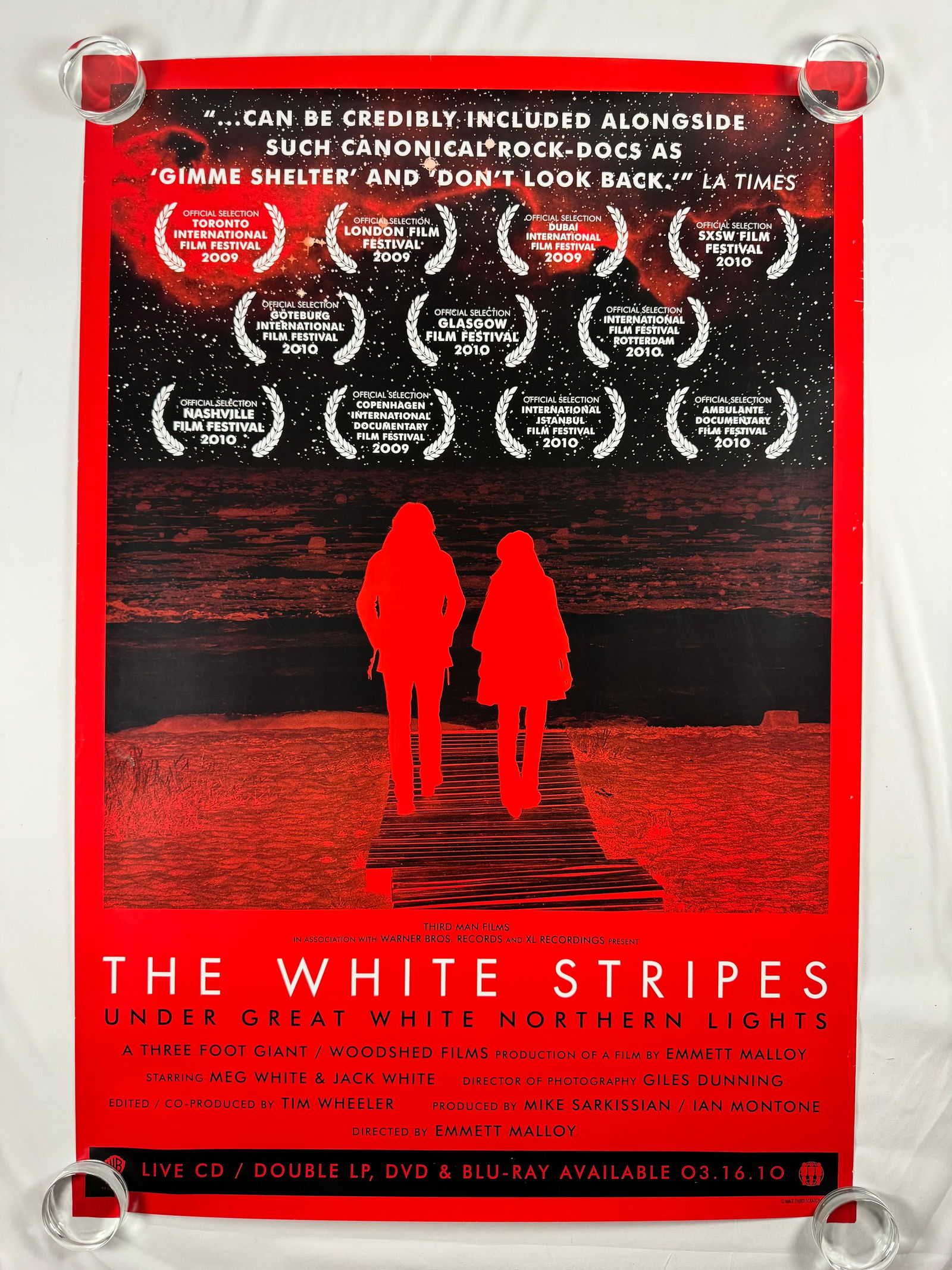 The White Stripes Under Great White Northern Lights UK Promo poster: Under Great White Northern Lights is a 2009 documentary film about the White Stripes' summer 2007 tour across Canada directed by Emmett Malloy. It contains live concert and off-stage footage. The film