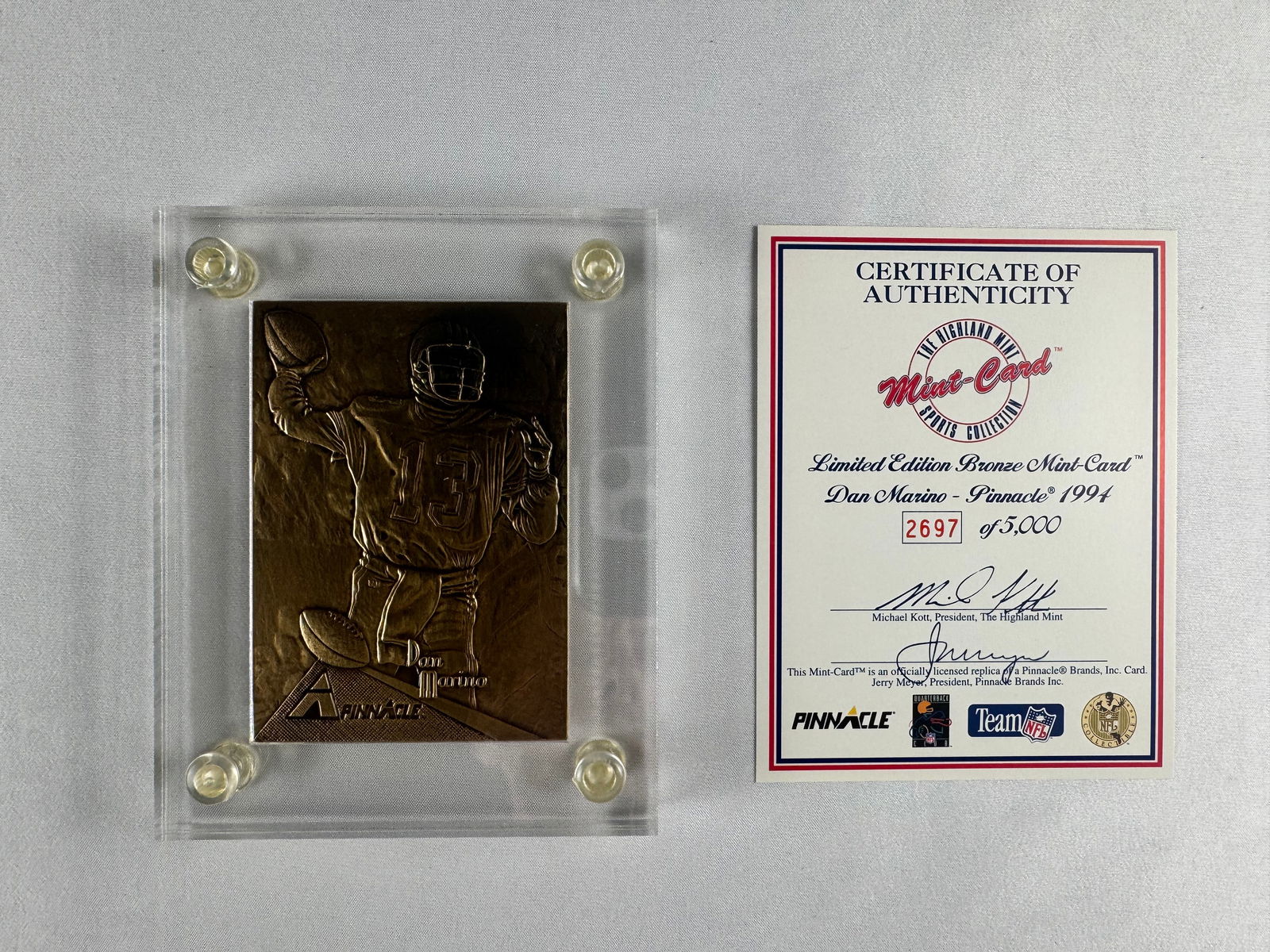 Dan Marino 1994 Pinnacle Bronze Mint Card with Certificate of Authenticity: Bronze Mint Card featuring Dan Marino issued by The Highland Mint in 1994. Includes original Certificate of Authenticity.