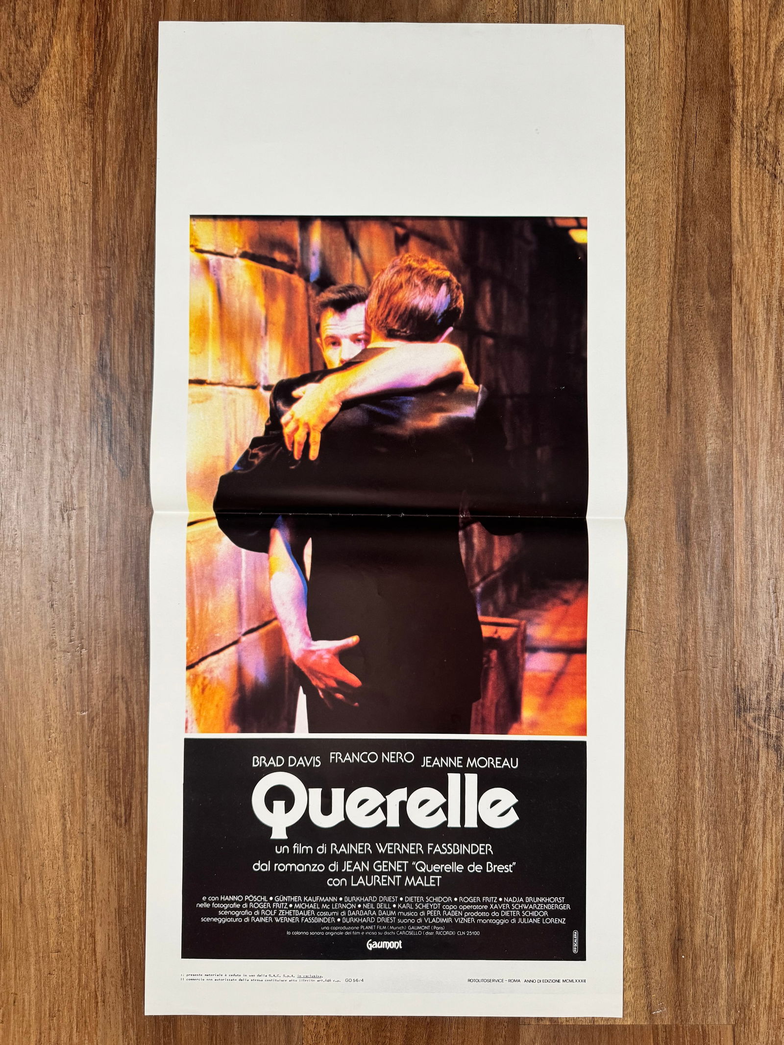 Querelle 1982 Italian Locandino Folded Movie Poster 13"x27.5" Gay Interest: Querelle is a 1982 English-language erotic art film directed by Rainer Werner Fassbinder. The film stars Brad Davis and was adapted from French author Jean Genet's 1947 novel Querelle of Brest. The pl