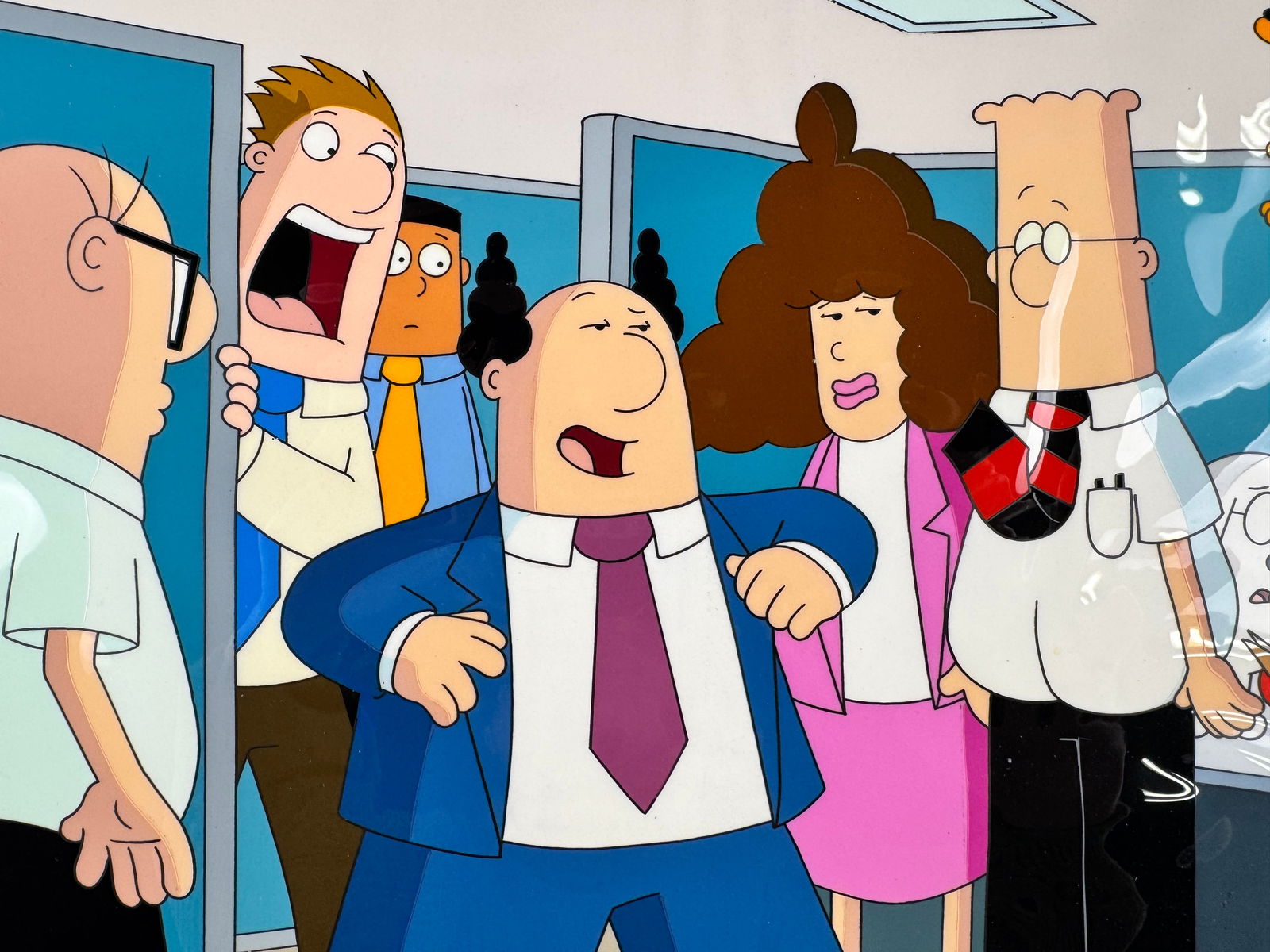 Dilbert 1999 Original Animation Production Cel Office Scene Signed Seth Kearsley w/ COA: This original animation production cel depicts multiple characters from Dilbert in an office scene. The cel is signed by Seth Kearsley and includes a certificate of authenticity.