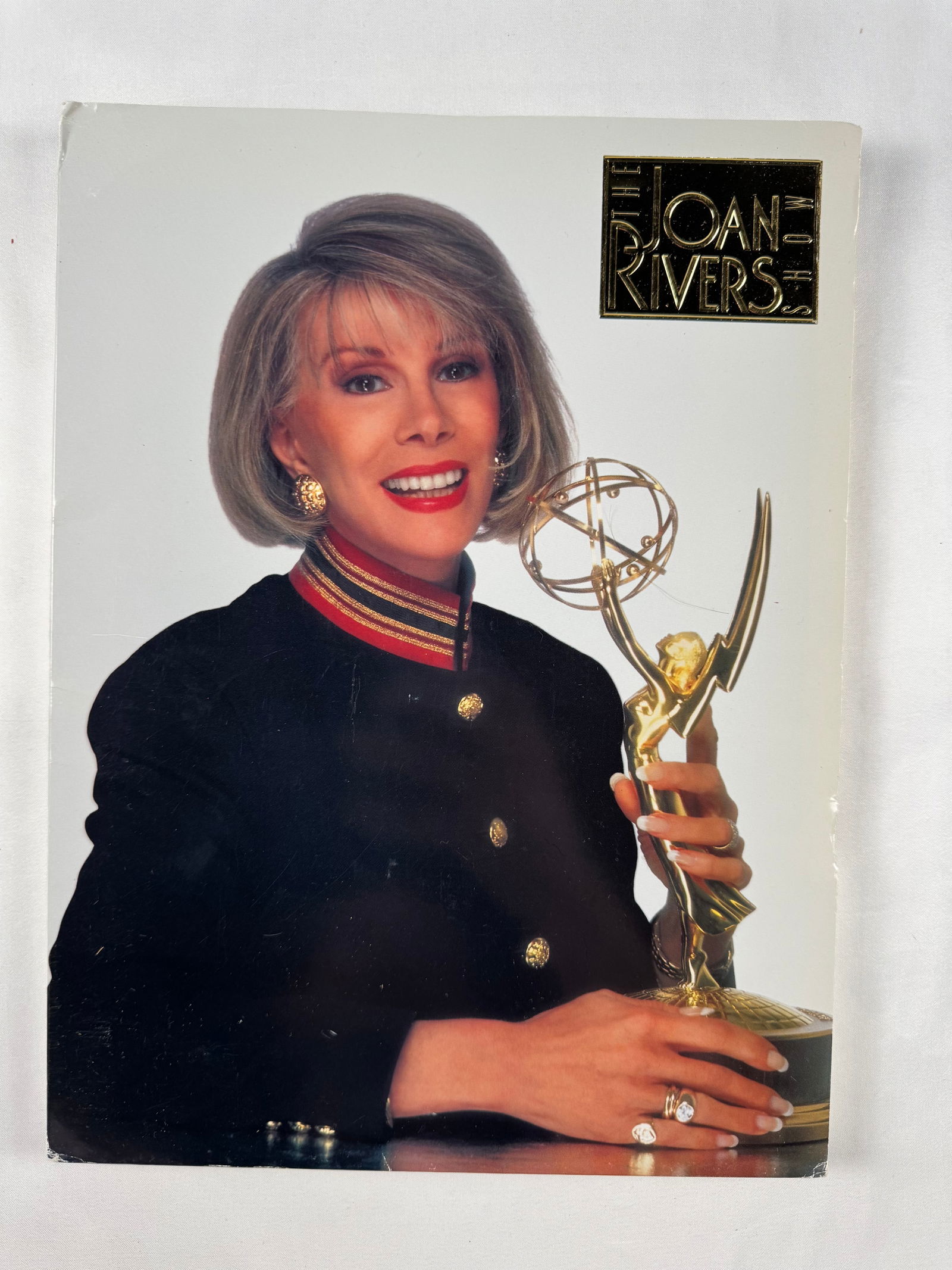 Joan Rivers Show 1990s Press Kit w/ Photos and Bios: A comprehensive Joan Rivers Show press kit including studio photos, bios, interview sheets, and show information; contents are well-organized in tabbed pockets with minor handling wear.