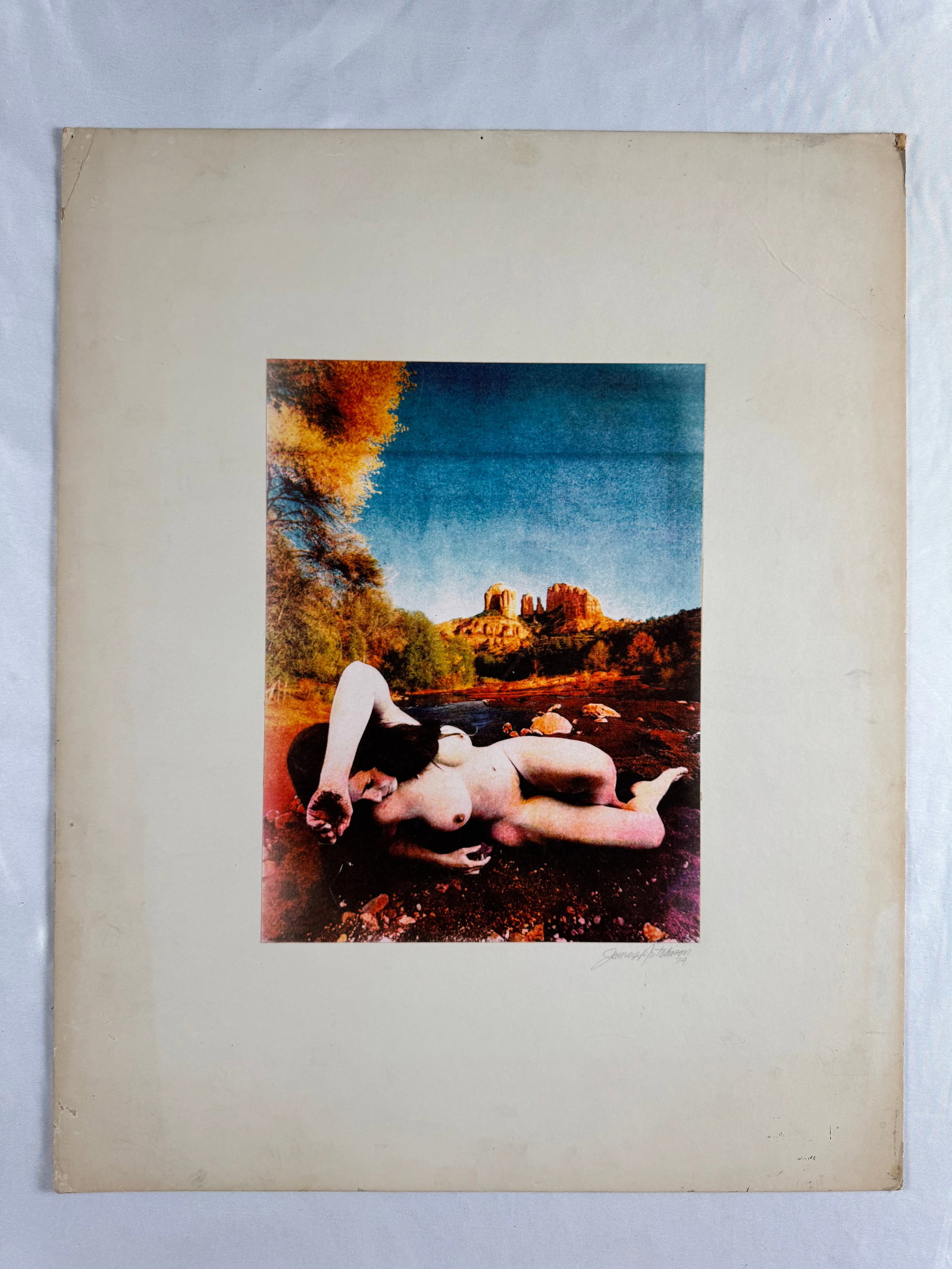 James H Hutchinson Surreal Nude Landscape 1974 Photograph Signed Color Print: Fine art photograph print depicting reclining nude figure in landscape setting. Signed James H Hutchinson and dated 1974 at lower margin.