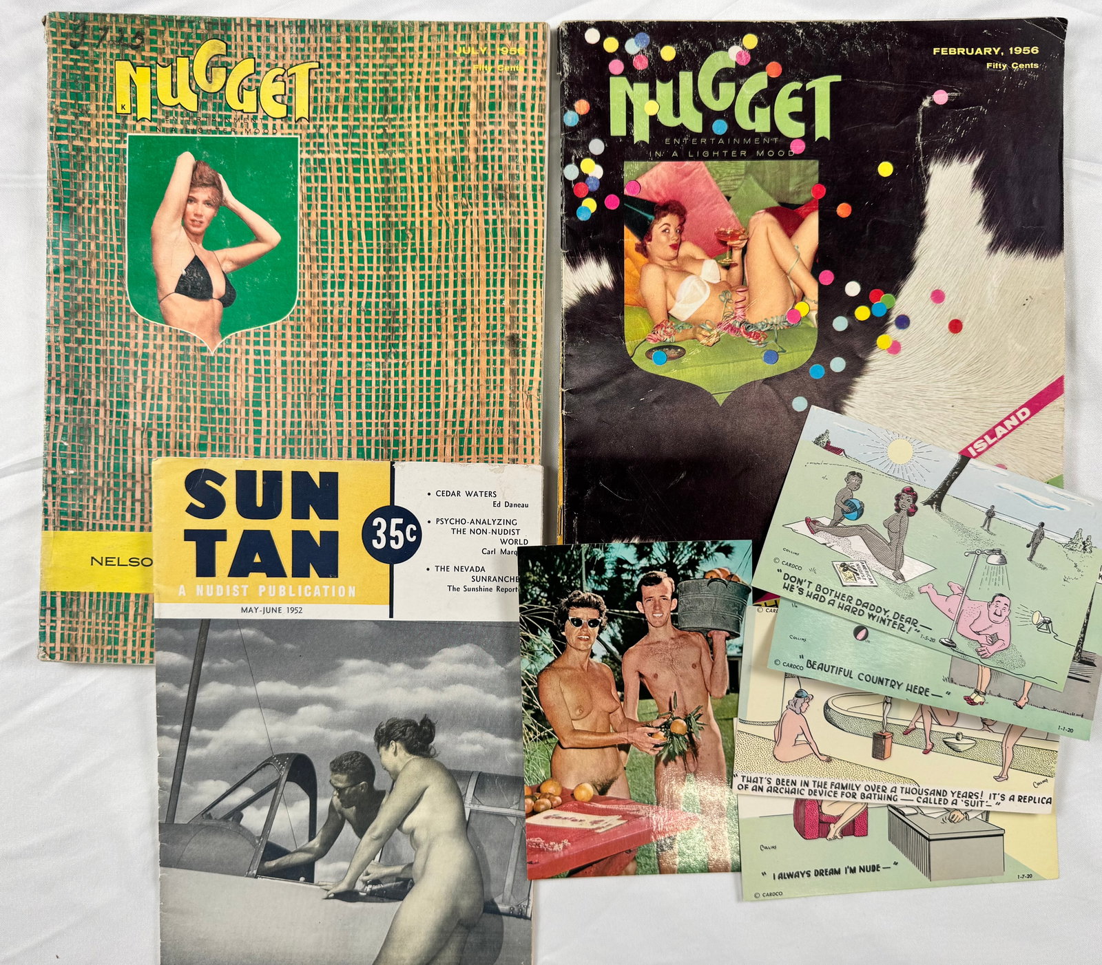 Lot of Vintage Nudist Magazines Postcards & Ephemera 1950s: Grouping of vintage nudist and naturist material including Nugget magazines, Sun Tan publication, postcards, and related ephemera. Includes illustrated humor postcards and vintage nude photography ima
