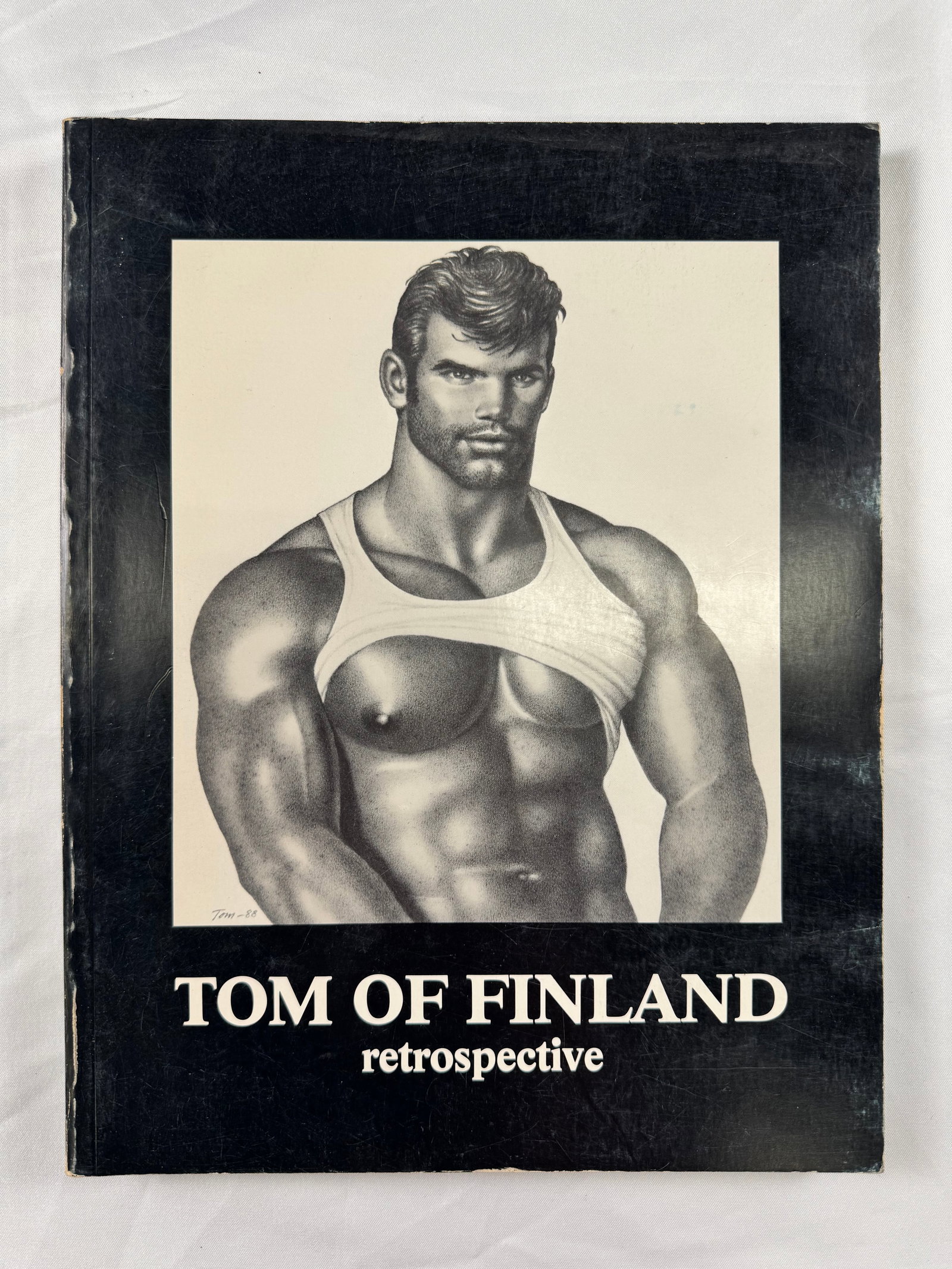 Tom of Finland Retrospective Signed by Lance Loud Vintage Gay Interest Art Book: Tom of Finland Retrospective softcover art book featuring illustrations and male figure studies by Tom of Finland. Signed and inscribed by Lance Loud on the front cover dated April 15, 1989.