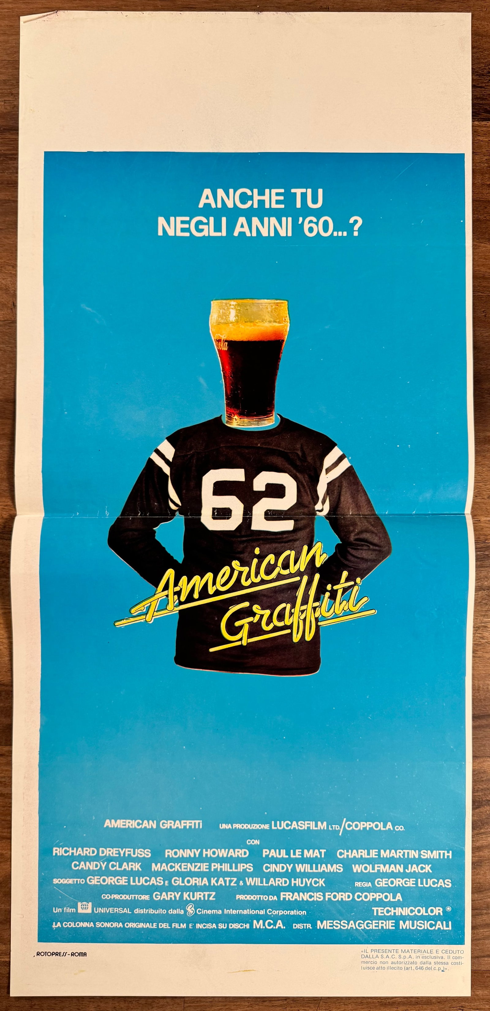 American Graffiti 1973 Italian Locandino Movie Poster George Lucas 13x27.5": American Graffiti (1973) directed by George Lucas, starring Richard Dreyfuss, Ron Howard and Paul Le Mat. Original folded Italian locandino poster for the coming-of-age comedy drama.