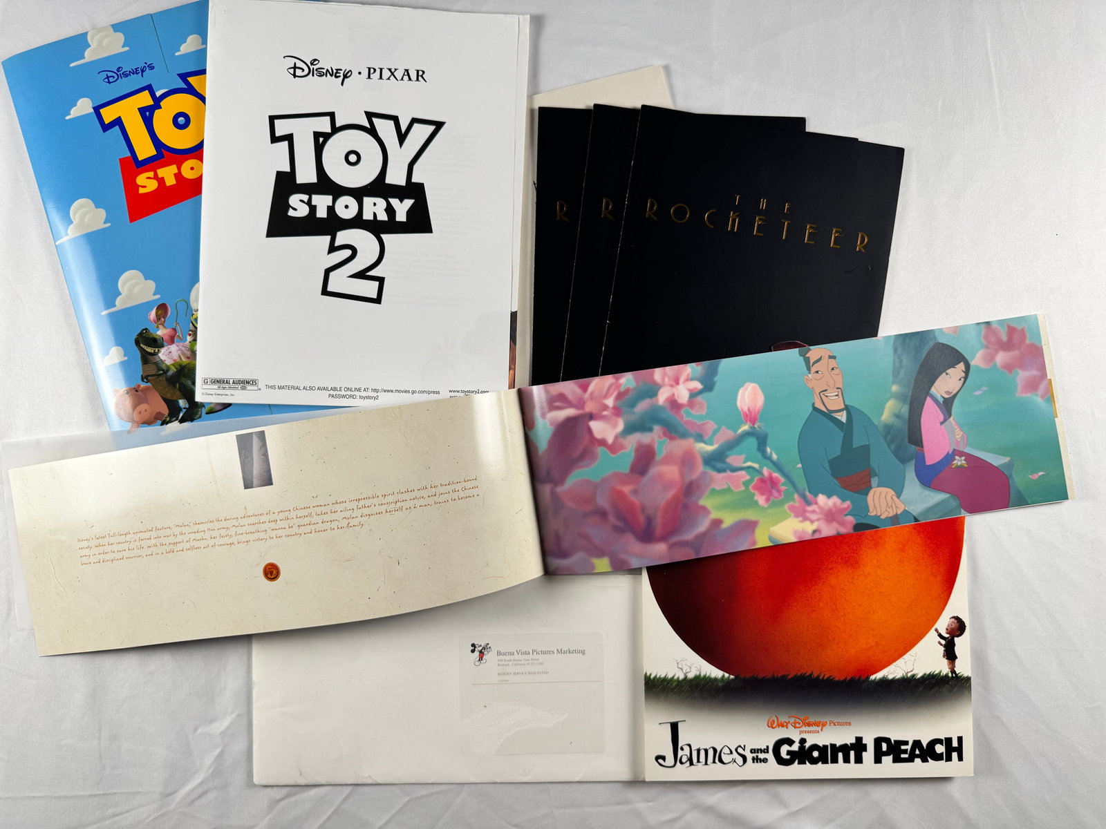 Lot of Disney Pixar Press Kits Toy Story 2 James and the Giant Peach Rocketeer: Includes Disney Pixar Toy Story 2 press materials, The Rocketeer press kits, and James and the Giant Peach promotional book. Printed studio materials from Walt Disney Pictures.