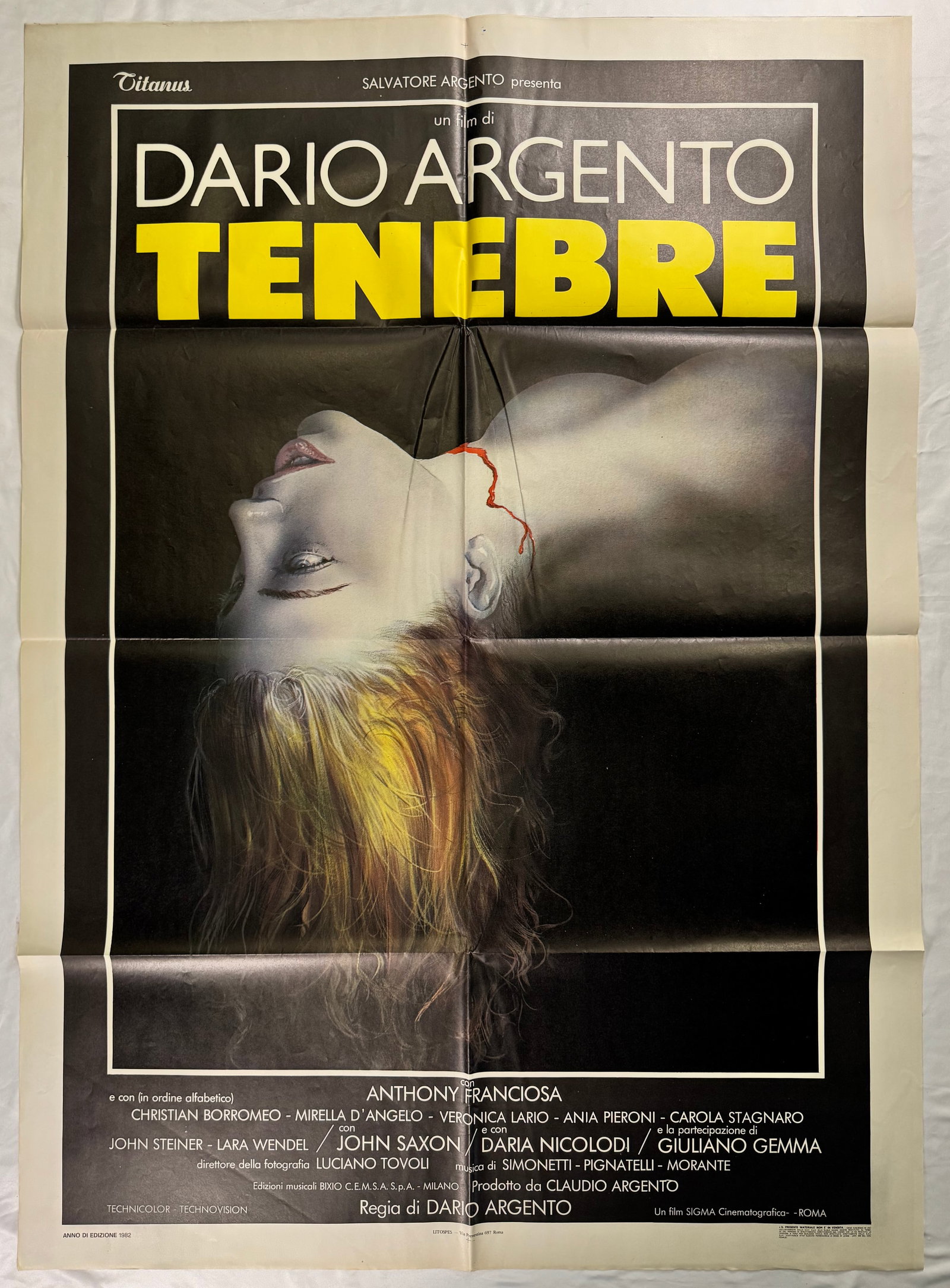 Tenebre 1982 Dario Argento Large Original 2 Fogli Italian 1P Folded Movie Poster 39x55": Tenebrae (lit.?'"darkness"', also known as Tenebre) is a 1982 Italian giallo film, written and directed by Dario Argento. The film stars Anthony Franciosa as American author Peter Neal, who – while 