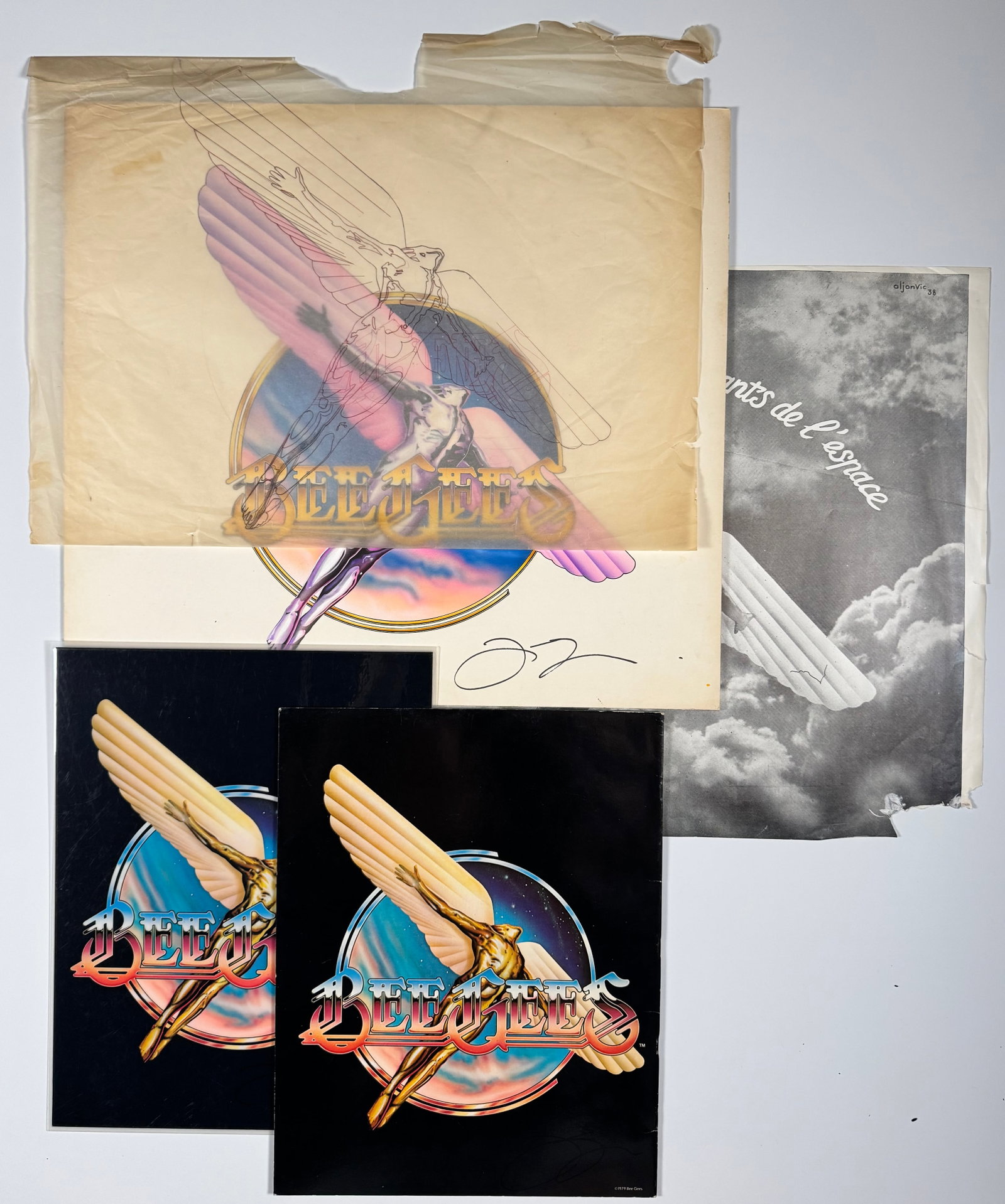 Joe Spencer Bee Gees Original Production Artwork Transparencies and Proofs: Lot of original production artwork materials related to the Bee Gees, including color proofs, overlay transparencies, and printed elements featuring the group's winged logo design. Includes hand drawn