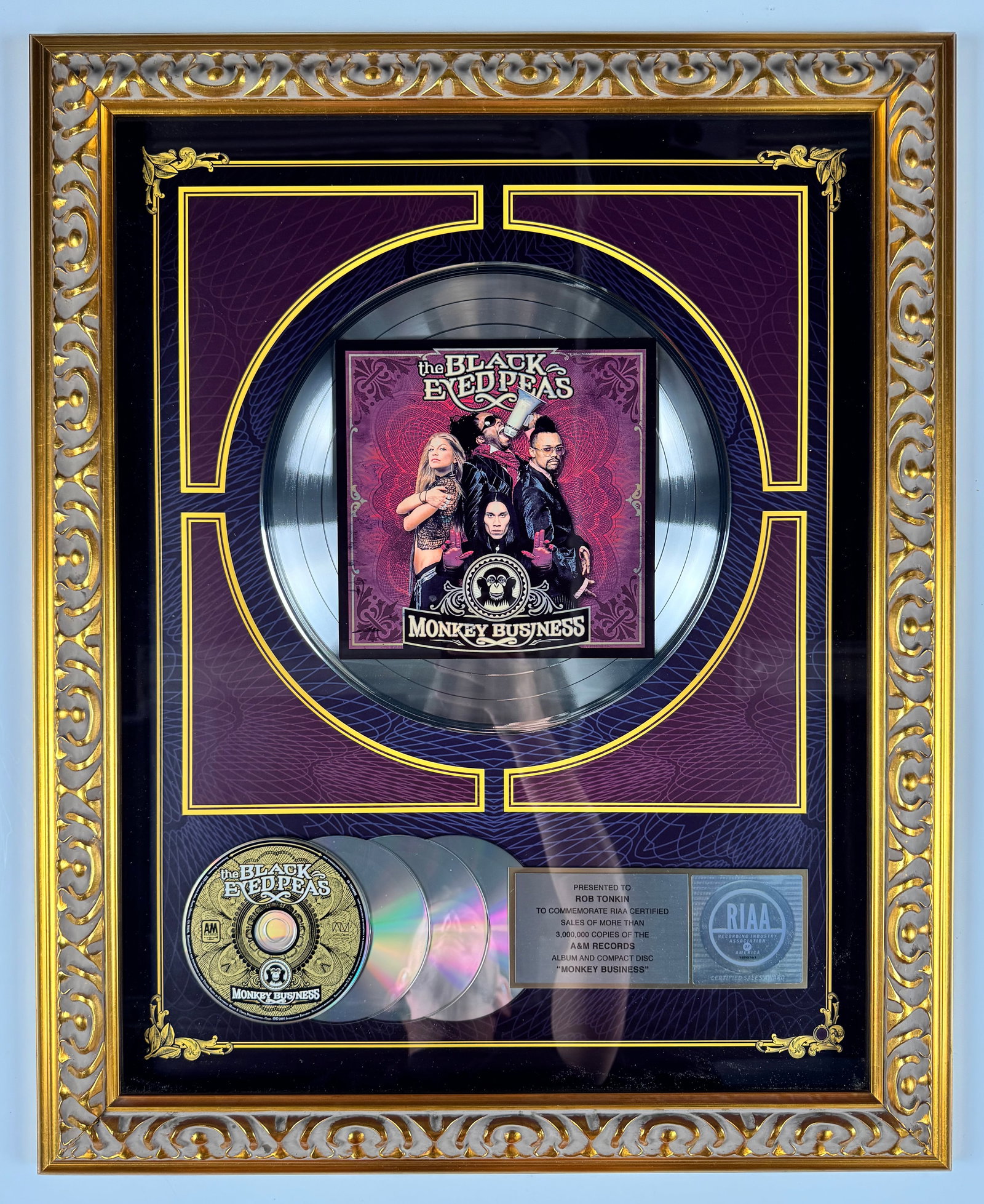 The Black Eyed Peas Monkey Business RIAA Triple Platinum Record Sales Award Display: Official RIAA-certified triple platinum sales award commemorating more than 3,000,000 copies sold of The Black Eyed Peas album Monkey Business. The display features a platinum record, multiple compact