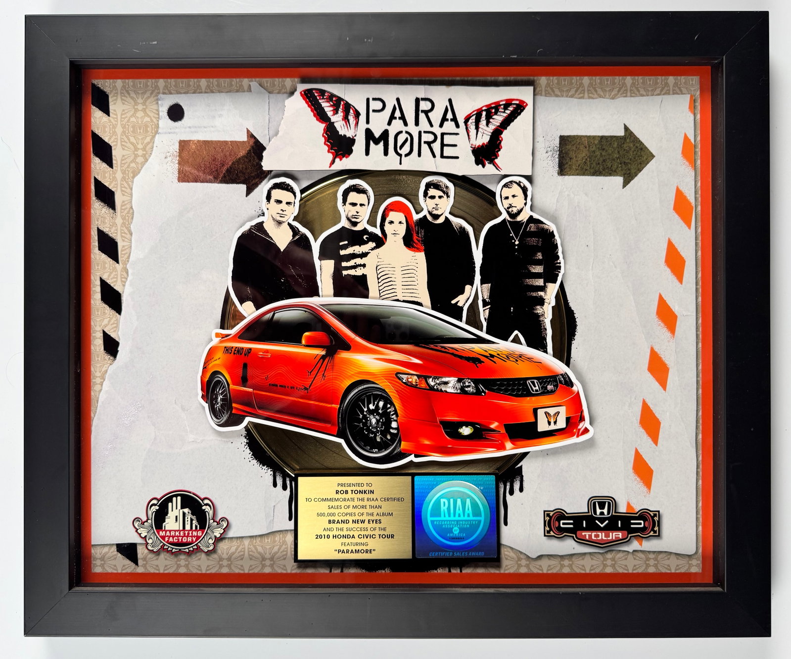 Paramore Brand New Eyes 2010 Honda Civic Tour RIAA Gold Record Sales Award Display: Official RIAA-certified gold sales award commemorating more than 500,000 copies sold of Paramore's Brand New Eyes and the 2010 Honda Civic Tour. The display features a gold record, band imagery, and a