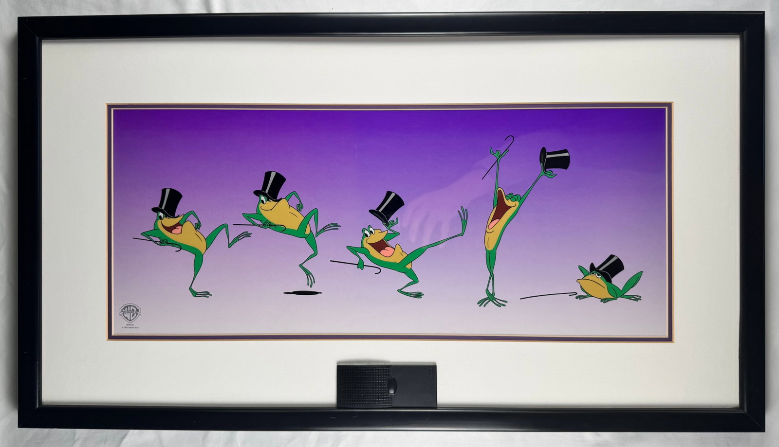 Warner Bros Michigan J Frog Animation Art Dance Sequence COA Sound 32.5x18.5": Warner Bros animation art featuring Michigan J Frog in multi pose dance sequence with top hat and cane. Includes certificate of authenticity and built in sound feature activated by button.