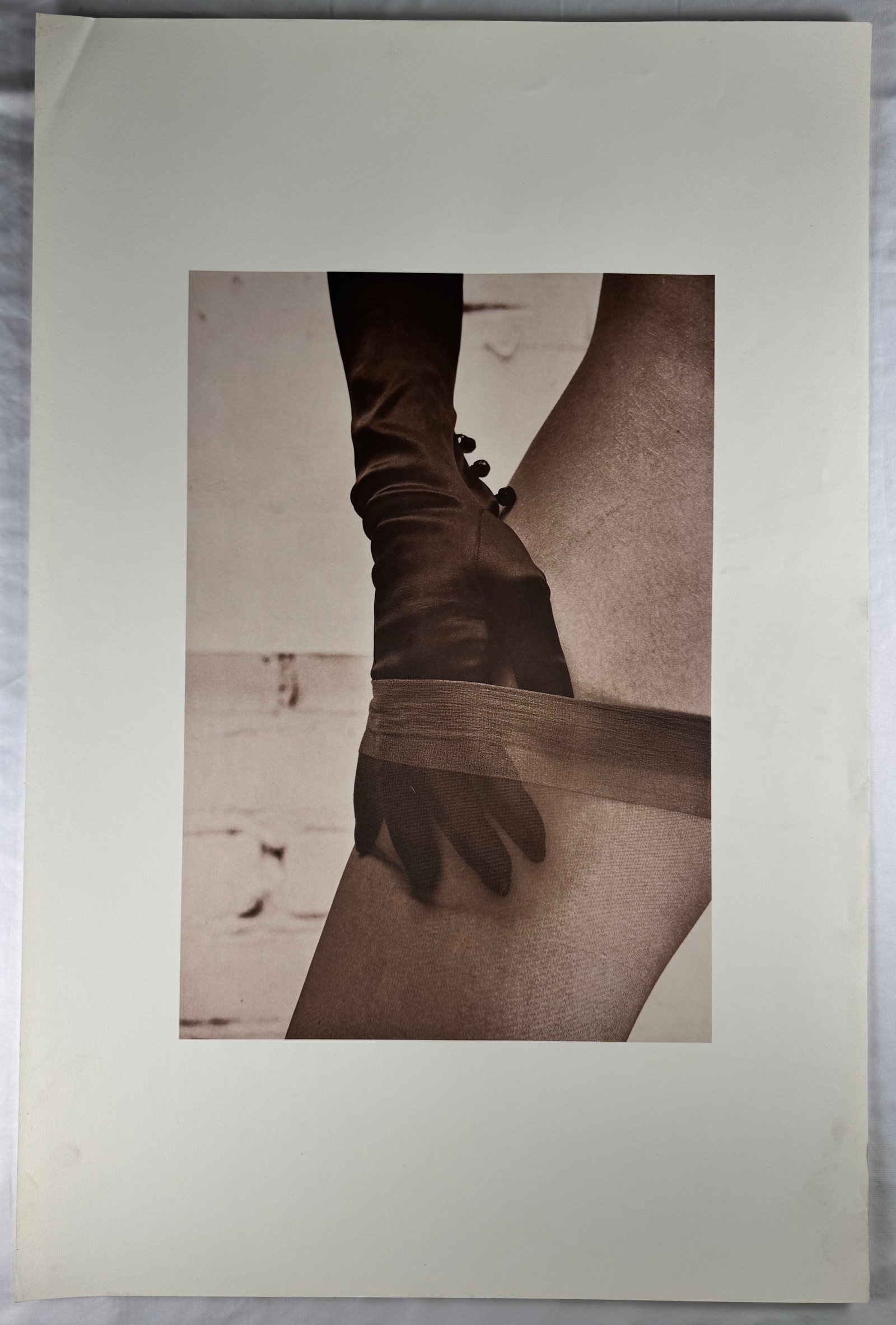 Harvey Edwards Erotic Photograph Gloved Hand Stocking Female Leg Study 25x38": Print by Harvey Edwards depicting a close view of a gloved hand adjusting a stocking on a female leg. Sepia-toned photographic composition presented with wide margins.