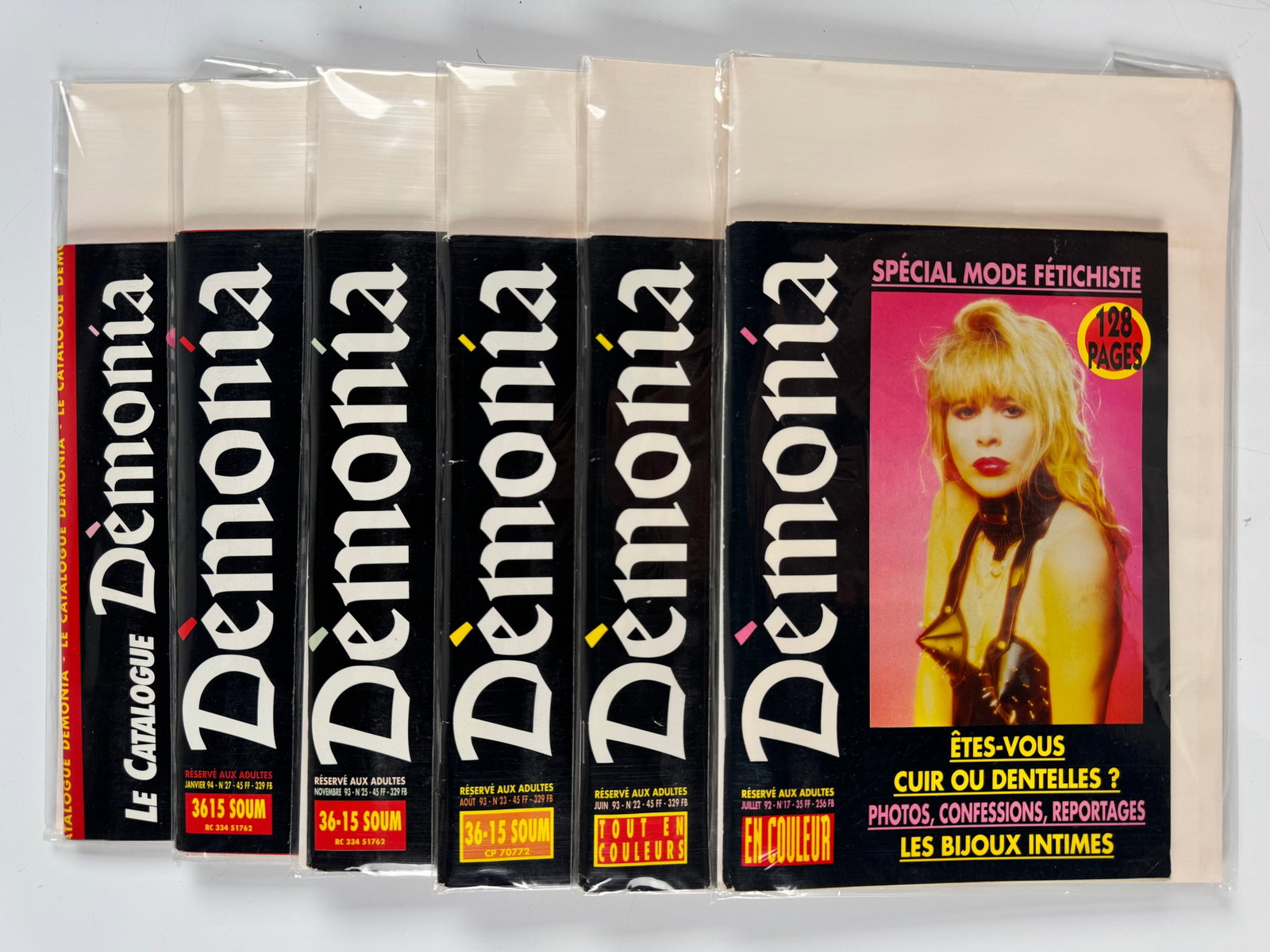 Démonia Nos. 17 22 23 25 27 Paris Comédit French BDSM Fetish Magazines Catalogue 1992-94 Lot 6: Six-piece group published in Paris by Comédit and Démonia, comprising No. 17 from July 1992, No. 22 from June 1993, No. 23 from August 1993, No. 25 from November 1993, No. 27 from January 1994 and a