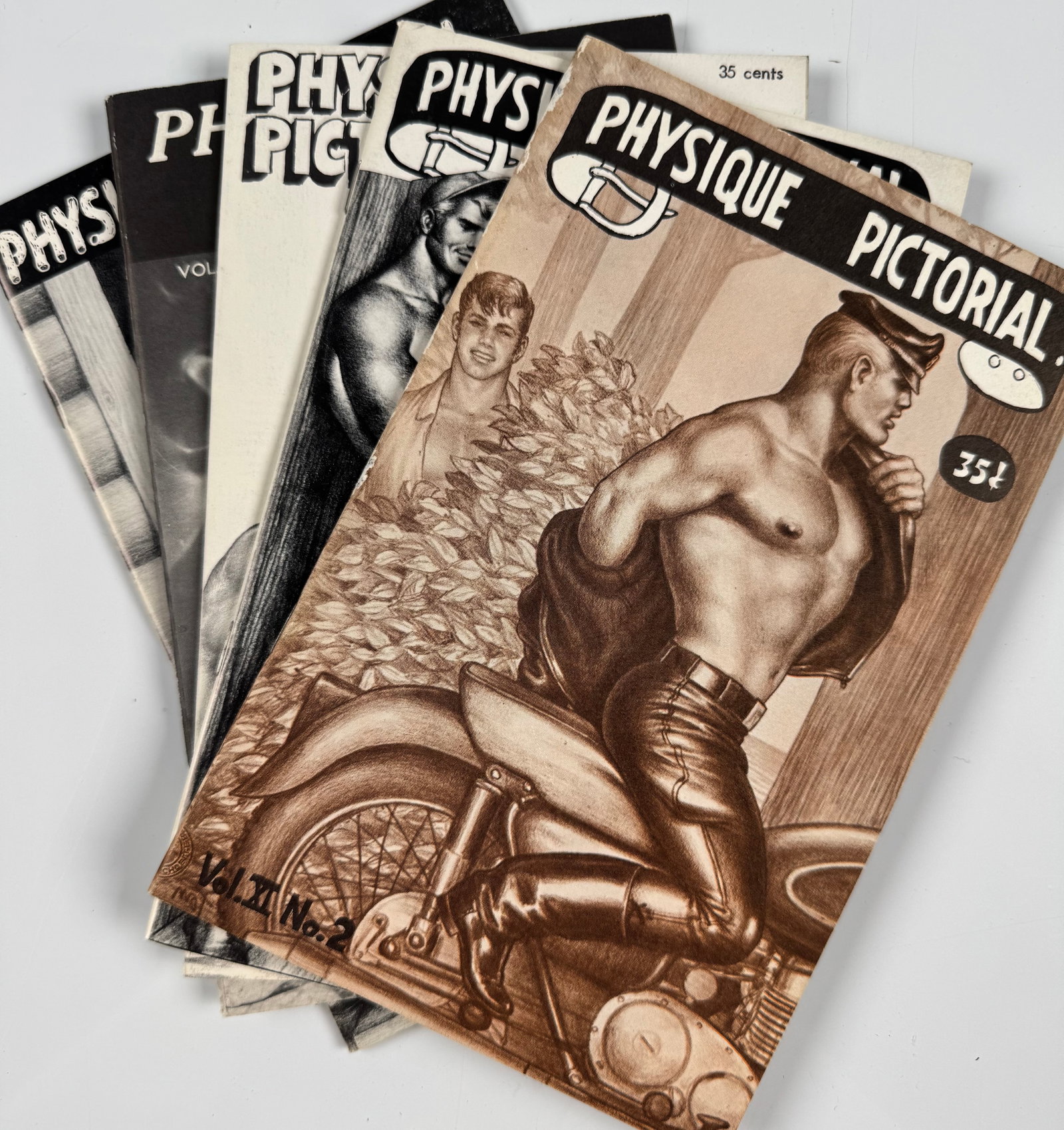Tom of Finland Bob Mizer Physique Pictorial 7 9 13 23 25 Homoerotic Beefcake Gay Male Nude Magazines: Lot of five original digest-size issues of Physique Pictorial, edited and published by photographer Bob Mizer through the Athletic Model Guild in Los Angeles. Includes Volume 7 No. 2, Summer 1957; Vol