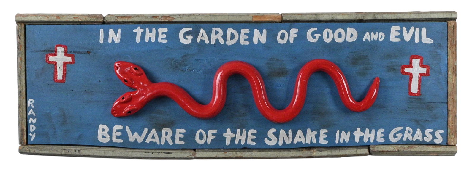 Randy Tobias. Double Headed Red Snake On Board: Randy Tobias. Double Headed Red Snake On Board. Signed. Red double headed pottery snake mounted to a wood board saying, "In the Garden of Good and Evil Beware of the Snake in the Grass". Framed using