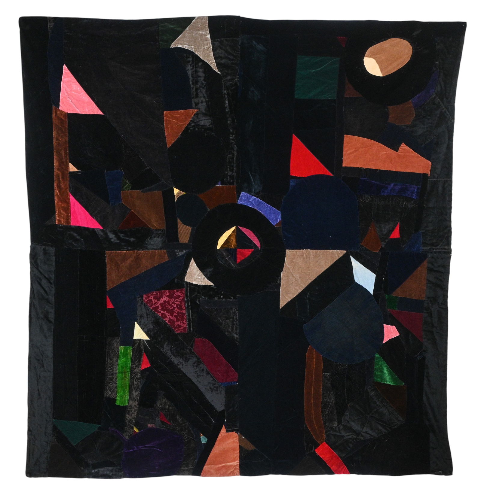 African American Quilt: African American Quilt. Made from plain and patterned velvets and fake fur, hand pieced and appliqued onto a muslin backing to give a quilted effect without an extra layer of quilting stitches. 