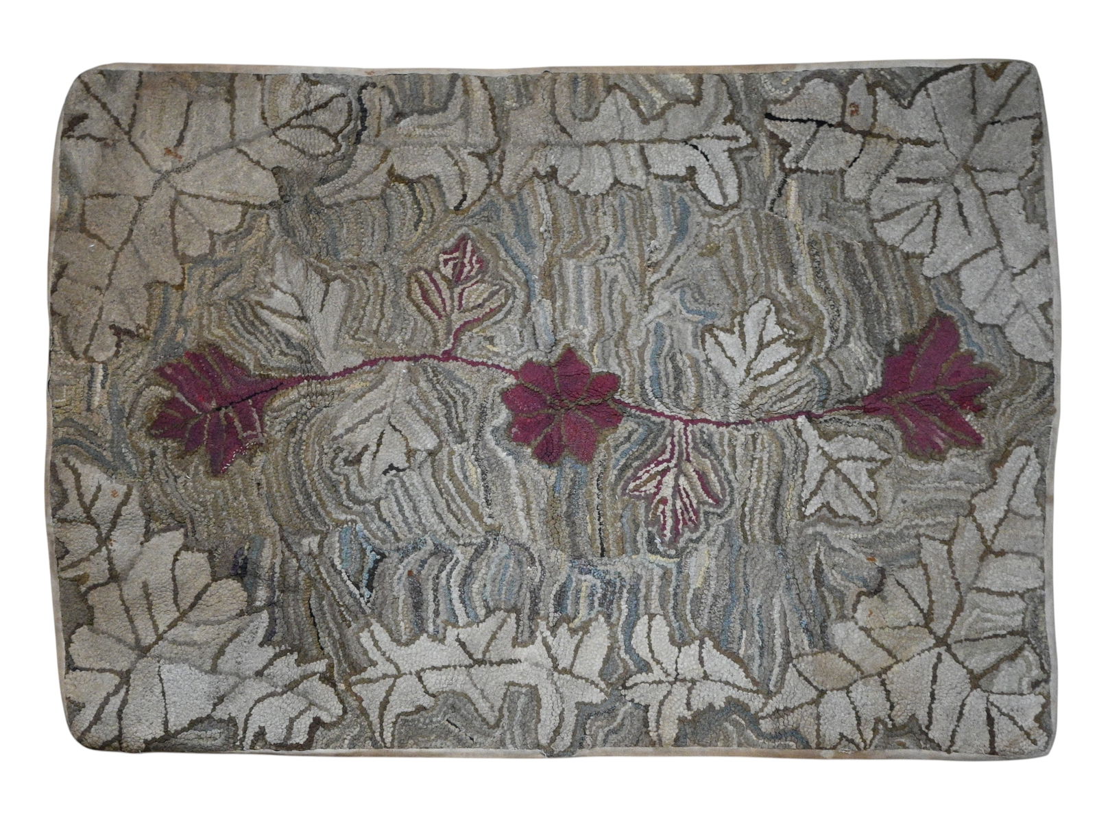 Leaf & Vine Hooked Rug: Leaf & Vine Hooked Rug. Handmade American hooked rug featuring an organic leaf and vine composition with burlap backing. Fair condition. Wear is present. Size: 34" H x 50" W. Provenance: 