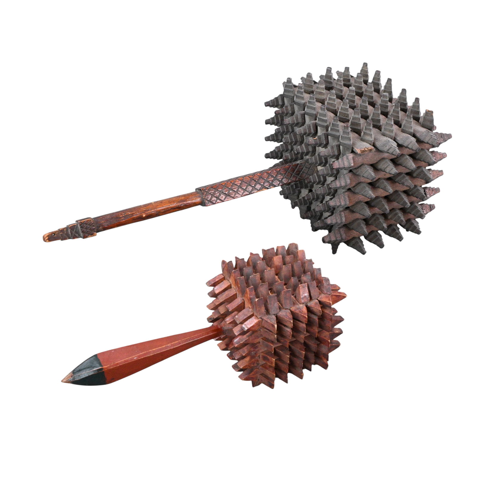 Pair of Tramp Art Rattles: Pair of Tramp Art Rattles. A rare and visually striking pair of tramp art wooden rattles, each deeply chip carved with dense, projecting geometric blocks forming sculptural heads. The rattles feature