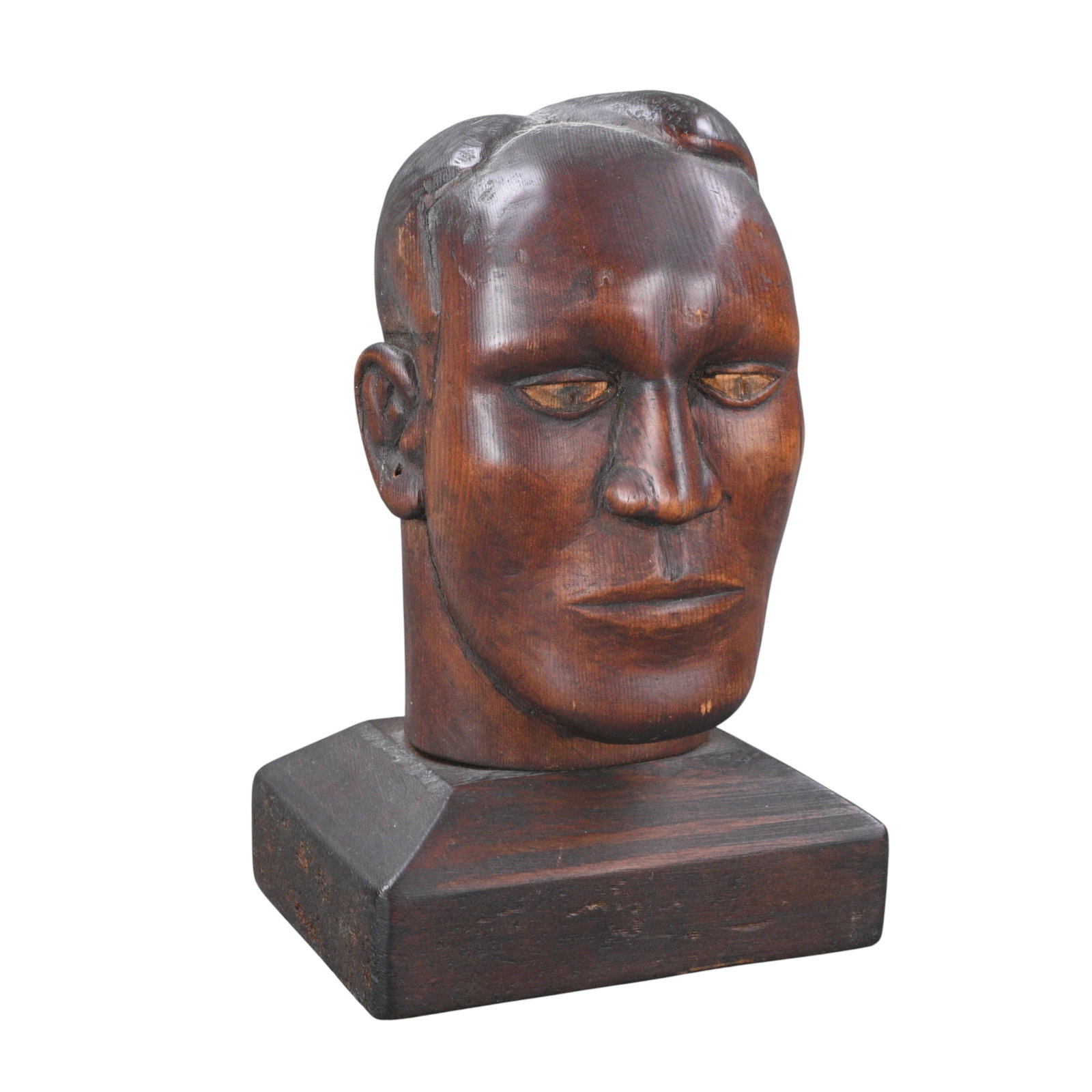 Carved Male Head: Carved Male Head. A finely carved wooden head mounted on a integral plinth. The surface retains a rich, dark brown patina with visible tool marks. Good condition. Minor surface wear. Size: 7" H