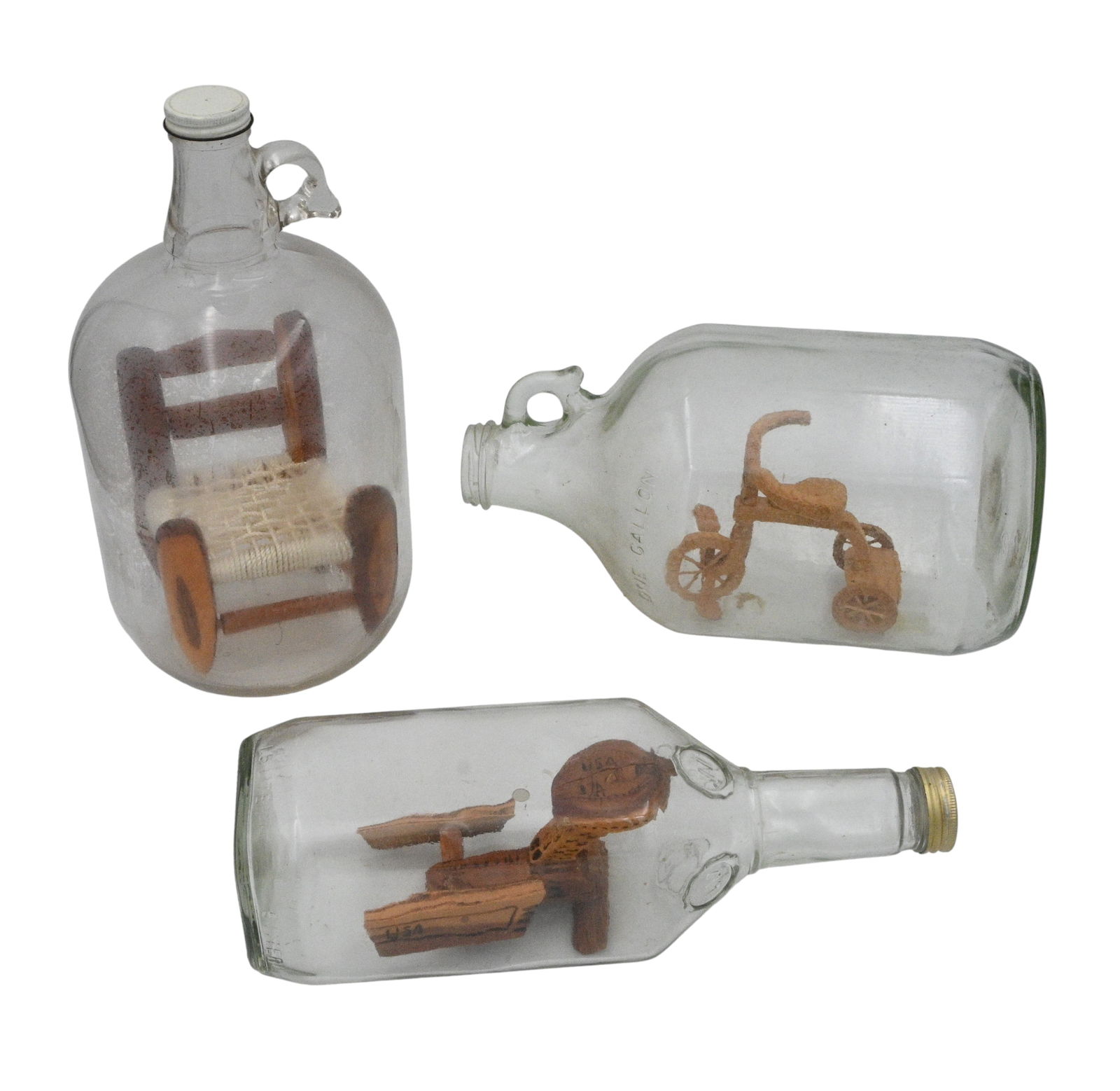 3 Whimsey Bottles: 3 Whimsey Bottles. Chair: Wood with a woven seat, sturdy and well done, built in a gallon jug with a screw top. Tricycle: Built in a one gallon jug. The tricycle is glued in place so the bottle can be