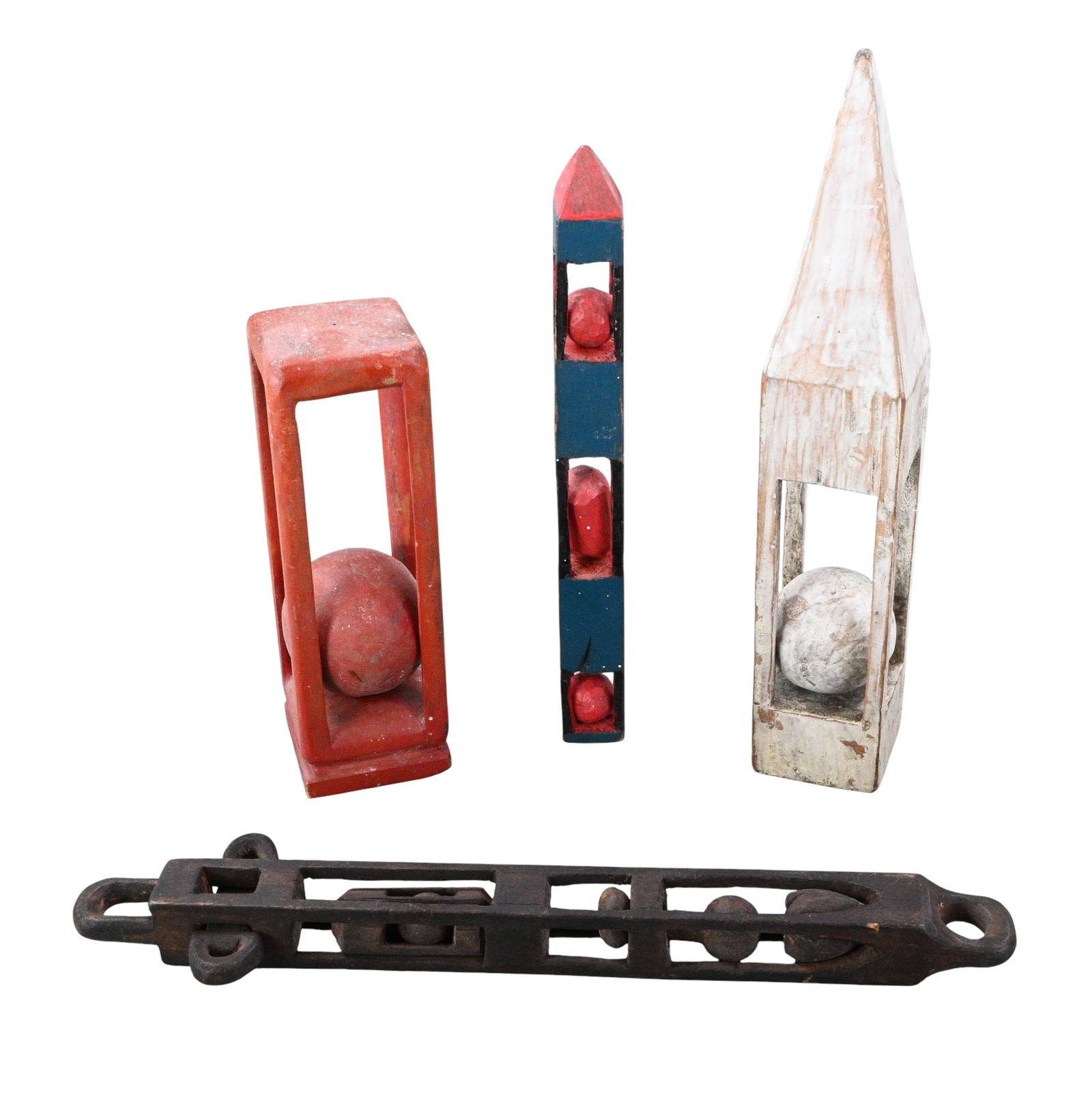 Group of Four Painted Carved Whimsies: Group of Four Painted Carved Whimsies. A distinctive group of hand carved folk whimsies exploring the classic "ball-in-cage" motif, rendered in boldly simplified geometric forms. Painted red,