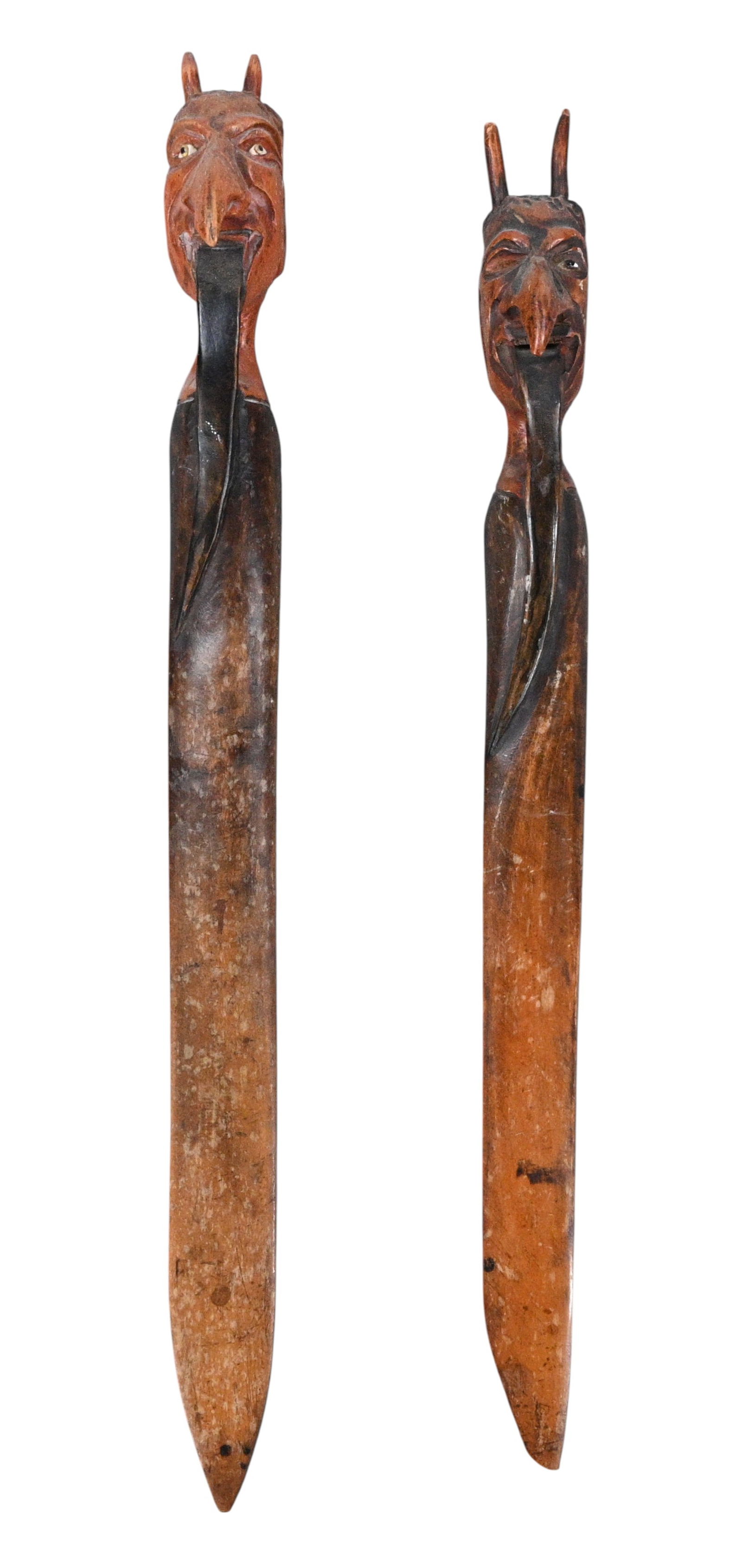Pair of Carved Folk Art Devil Head Letter Openers: Pair of Carved Folk Art Devil Head Letter Openers. Matched pair of carved wooden letter openers, each surmounted by a finely carved devil's head with large noses and an elongated tongue form extending