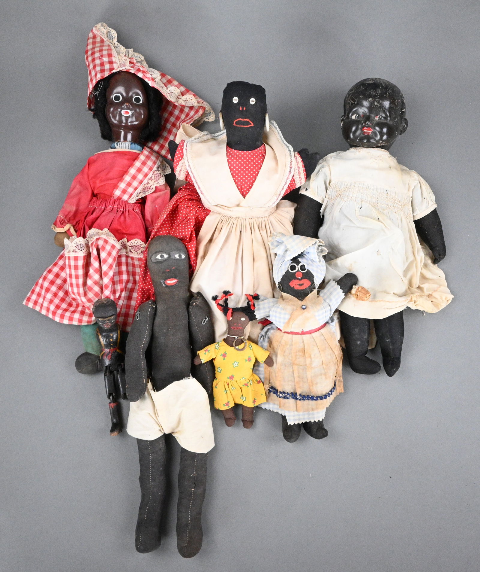 Group of African American Dolls: Group of African American Dolls. Combination of wood, felt, or plastic. Total of seven dolls. Fair condition. Clothes show wear. Size: Largest is 20" tall. Provenance: Private Georgia